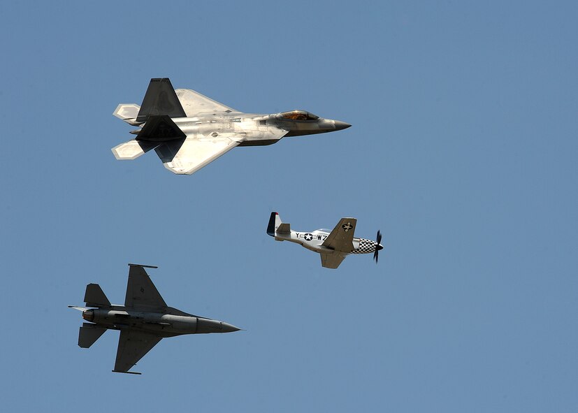 An F-22 Raptor, top, P-51 Mustang, center, and an F-16 Fighting Falcon fly over Barksdale Air Force Base, La., April 26, 2014. The aircraft flew together during an Air Force Heritage flight exhibiting the professional qualities the Air Force develops in the people who fly, maintain and support these aircraft. (U.S. Air Force photo/Senior Airman Joseph A. Pag?n Jr.)