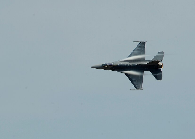 An F-16 Fighting Falcon flies over the flightline during the Defenders of Liberty Air Show on Barksdale Air Force Base, La. April 25, 2014. The F-16 provides a relatively low-cost, high-performance weapon system for the United States and allied nations. (U.S. Air Force photo/Senior Airman Joseph A. Pag?n Jr.)