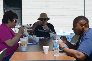 Navy Capt. Timothy Sparks, Joint Base Charleston deputy commander (center), along with Jackie Gardner, wife of Command Master Chief Petty Officer Joseph Gardner, and Senior Chief Petty Officer Vince Stephens, 628th Security Forces Squadron, judge different styles of chili April 25, 2014, during the Naval Support Activity Chili cook-off in support of Sexual Assault Awareness Month at Joint Base Charleston. Lt. Cmdr. Sean McMichael, 628th Security Forces Squadron, cooked up the winning batch of chili, beating out nine other contestants. (U.S. Air Force photo/Eric Sesit)