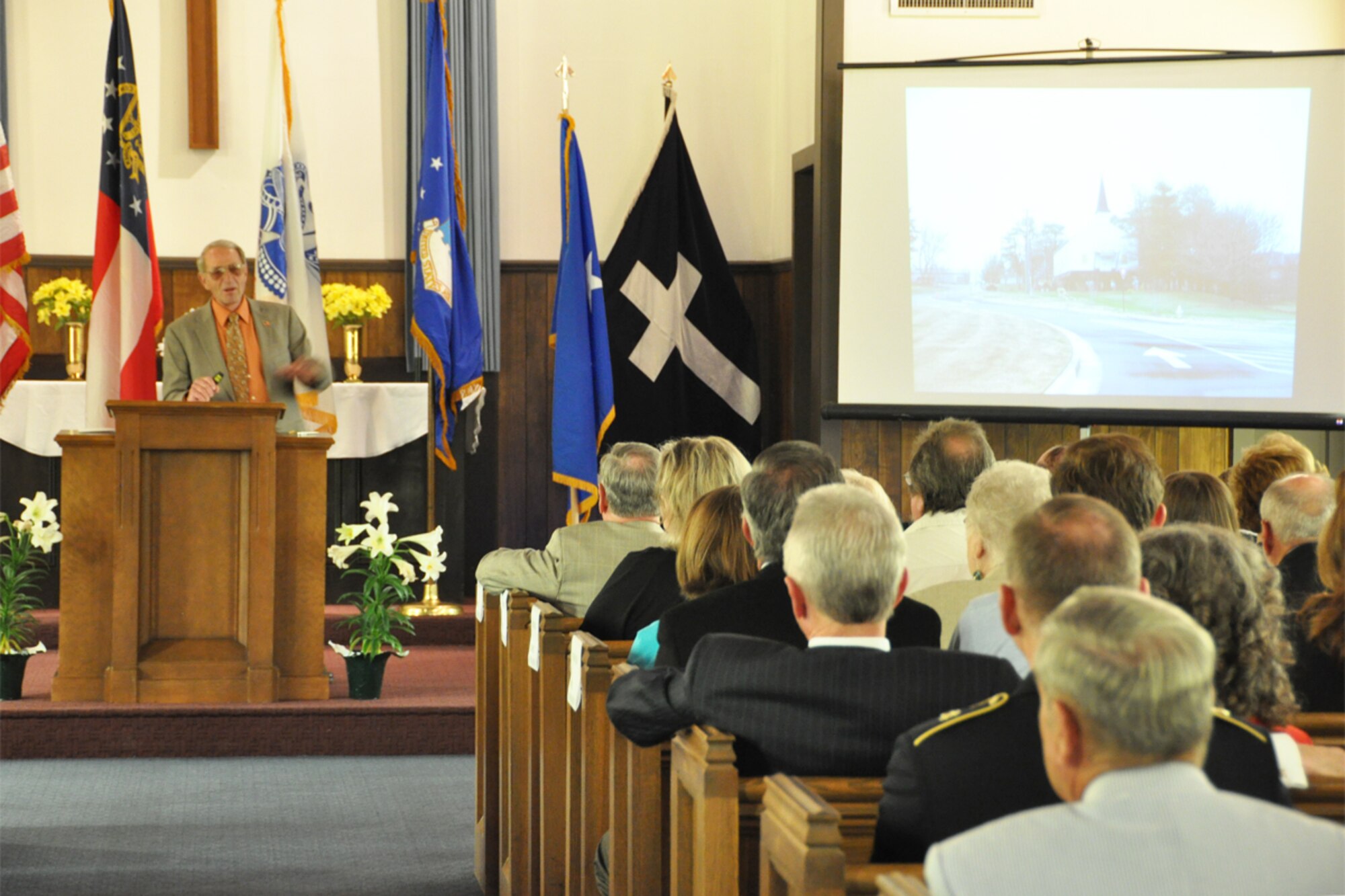 Col. (Ret) John Powers of the Dobbins Chapel Foundation, presents a timeline of events leading up to the relocation and rededication of the historic Dobbins chapel during a Rededication and Transfer of Ownership Ceremony at the Gen. Lucius D. Clay National Guard Center April 27. The chapel was relocated from Dobbins Air Reserve Base to the Clay NGC in March 2013. (U.S. Air Force photo/James Branch)