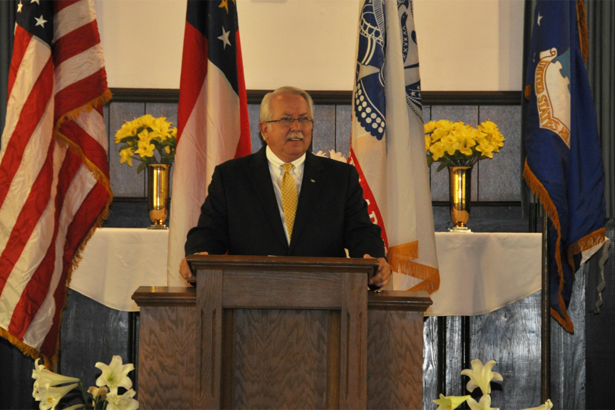 Col. (Ret) Allen Withers, guest speaker and former chaplain, gives remarks during a base chapel Rededication and Transfer of Ownership Ceremony at the Gen. Lucius D. Clay National Guard Center April 27. The chapel was relocated from Dobbins Air Reserve Base to the Clay NGC in March 2013. (U.S. Air Force photo/James Branch)
