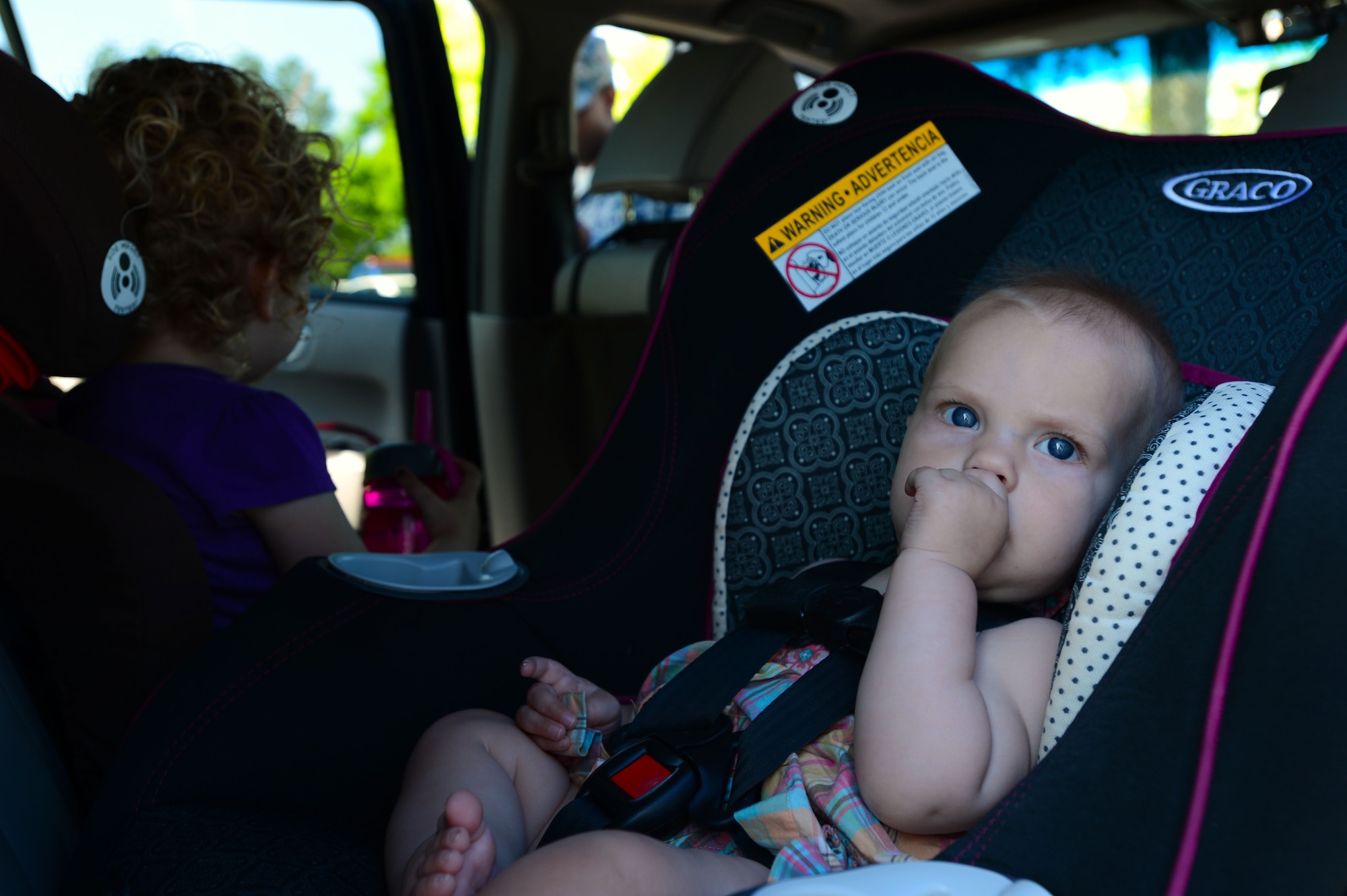 A child sits in a car seat after the seat was properly installed at Shaw Air Force Base, S.C., April 24, 2014.  The 20th Fighter Wing Safety Office inspected car seats to ensure that children were the proper weight and height for the seat they used. (U.S. Air Force photo by Airman 1st Class Jensen Stidham/Released)