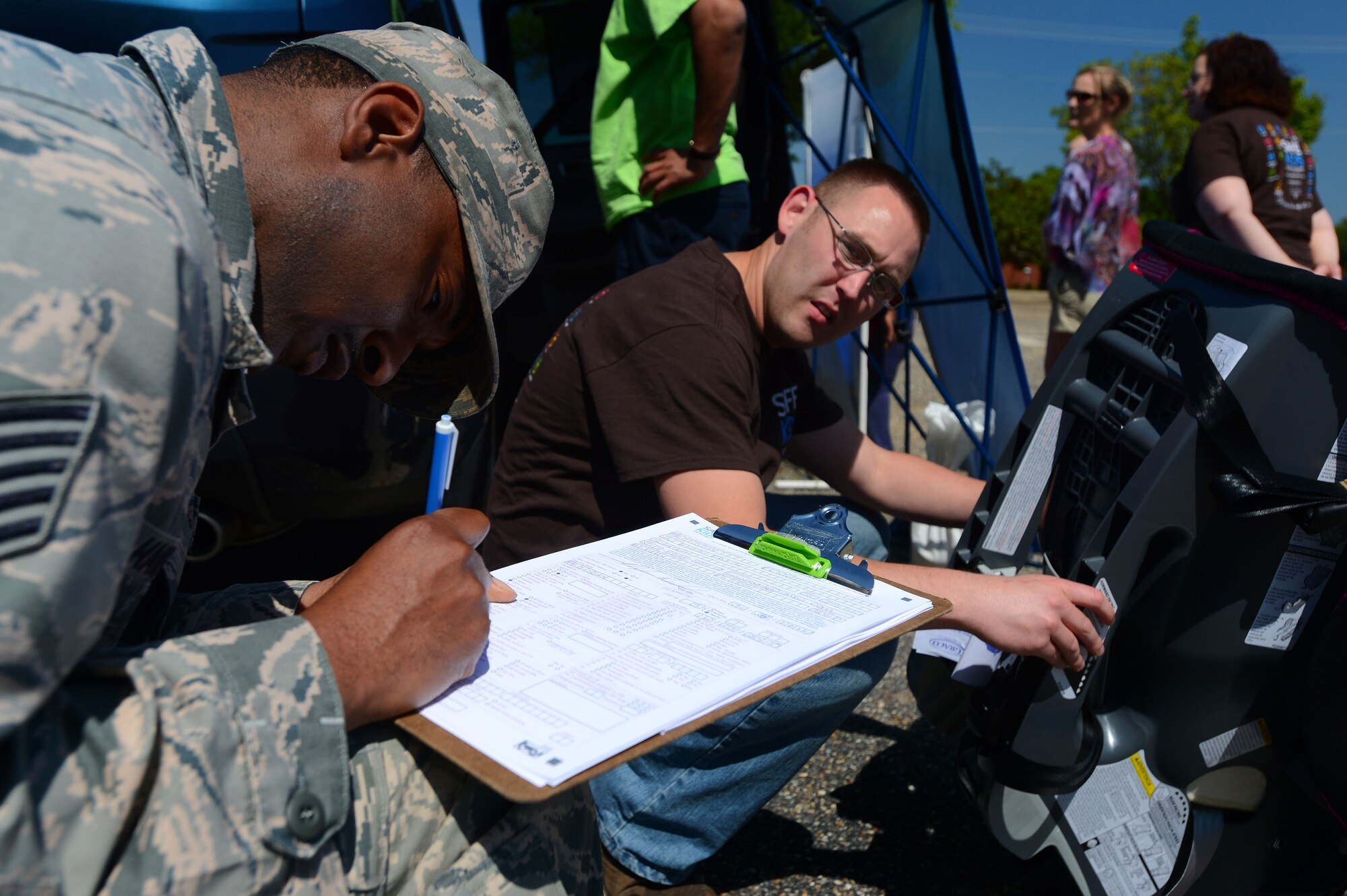 U.S. Air Force Tech. Sgt. Terry Hawkins, 20th Fighter Wing NCO in charge of flightline safety, fills out a car seat inspection evaluation for at Shaw Air Force Base, S.C., April 24, 2014.  Throughout the day several car seats were inspected and properly re-installed in cars to ensure childrens safety while riding in a vehicle. (U.S. Air Force photo by Airman 1st Class Jensen Stidham/Released)