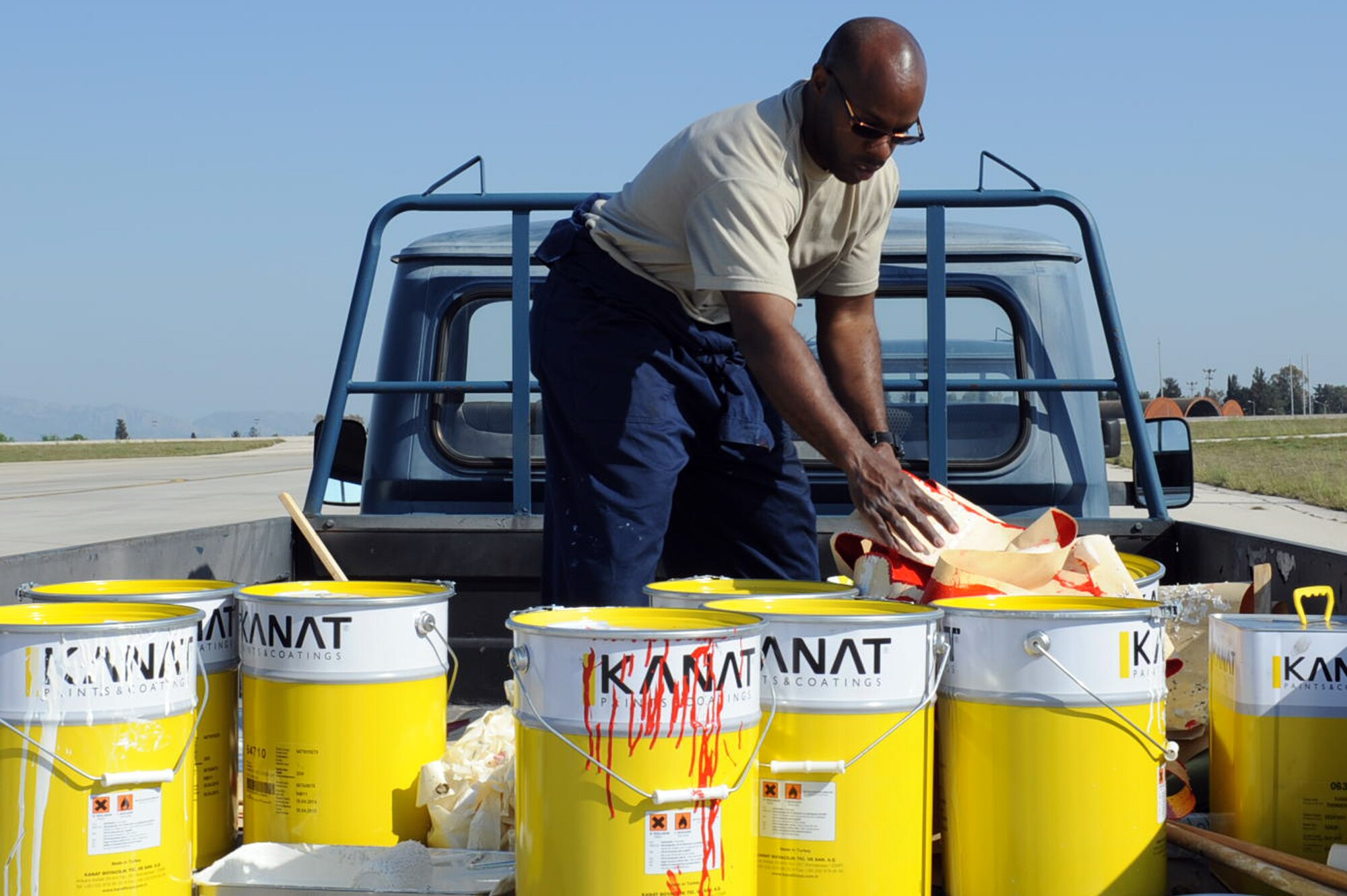 Tech. Sgt. Carlton Hill, 39th Civil Engineer Squadron operations engineering flight chief, loads a truck with stencils and paint April 22, 2014 at Incirlik Air Base, Turkey. Hill was one of more than ten 39th CES members involved in painting new Controlled Movement Area markings to improve safety standards. (U.S. Air Force photo by Staff Sgt. Eboni Reams/Released)