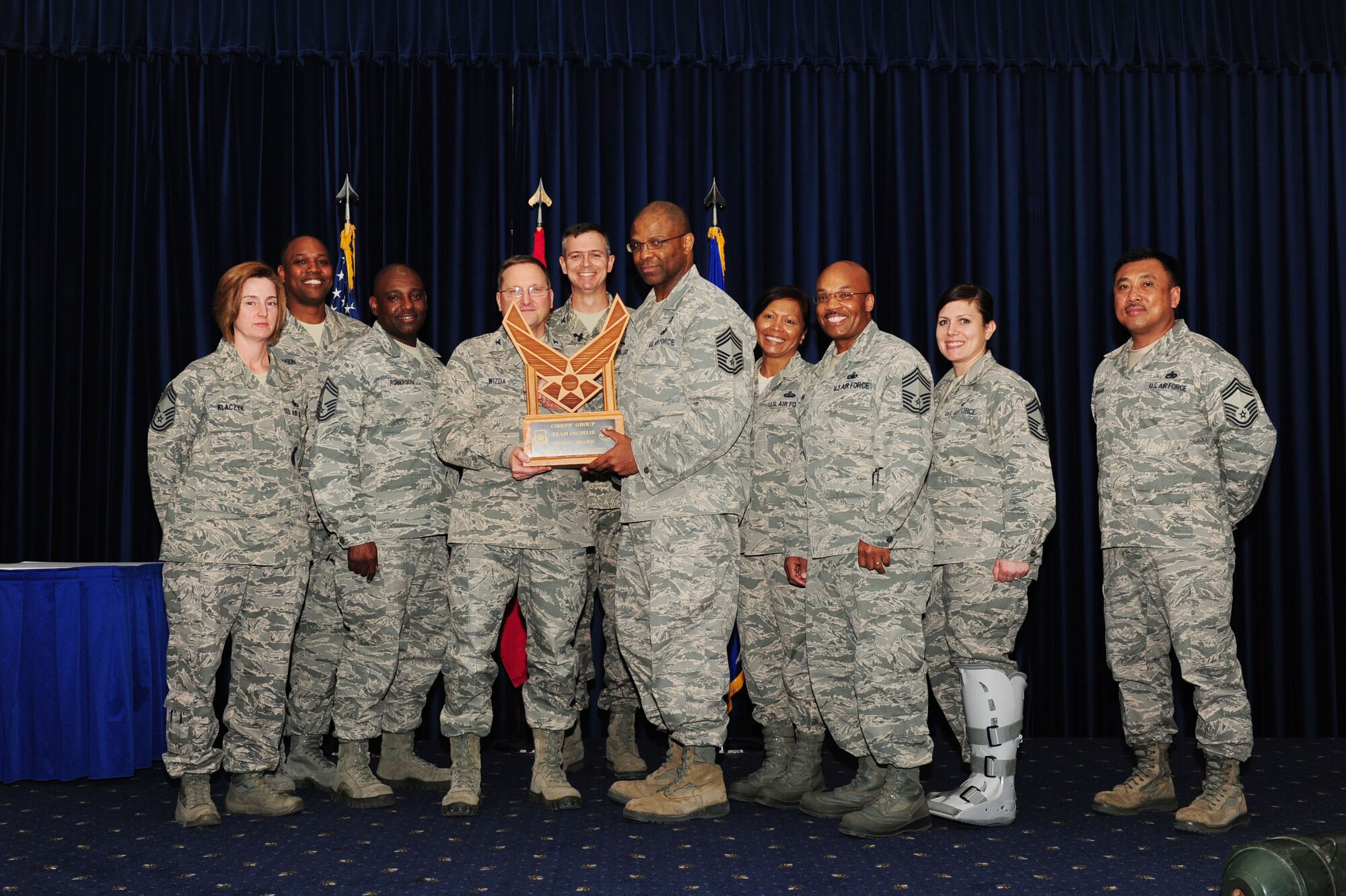 Col. Jerome Wizda, 39th Medical Group commander, center, accepts the Chief's Spirit Award from the Incirlik Air Base Chief’s Group during the promotion and awards ceremony April 25, 2014, Incirlik AB, Turkey. The award is presented to the unit that displays the most esprit de corps during the ceremony. (U.S. Air Force photo by Senior Airman Nicole Sikorski/Released) 

