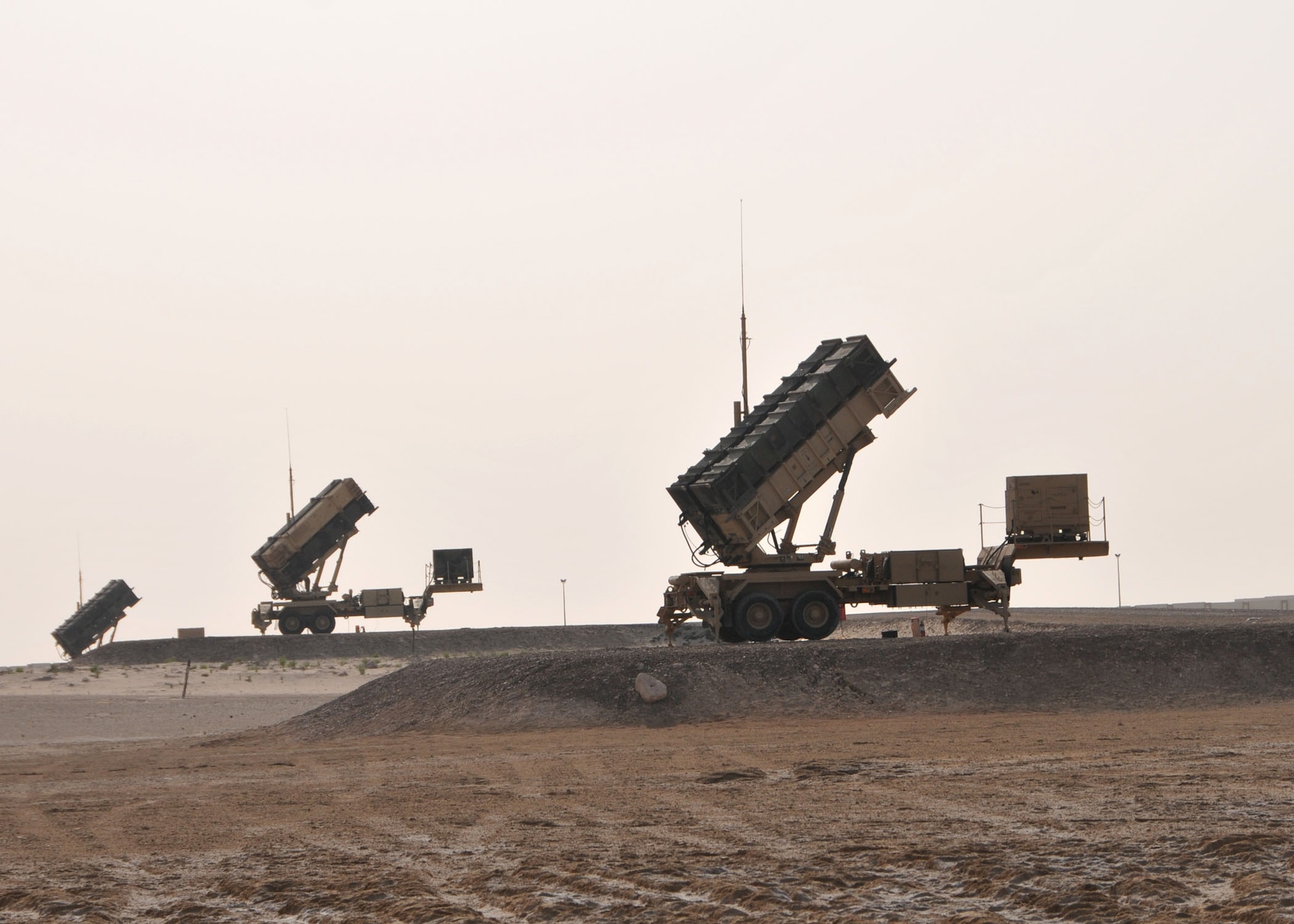 A set of three Army Patriot missile launchers assigned to Charlie Battery, 3rd Battalion, 4th Air Defense Artillery Regiment stand ready to defend the 380th Air Expeditionary Wing against airborne threats to at an undisclosed location in Southwest Asia on April 24, 2014. (U.S. Air Force photo by Senior Master Sgt. Eric Peterson/Released)

