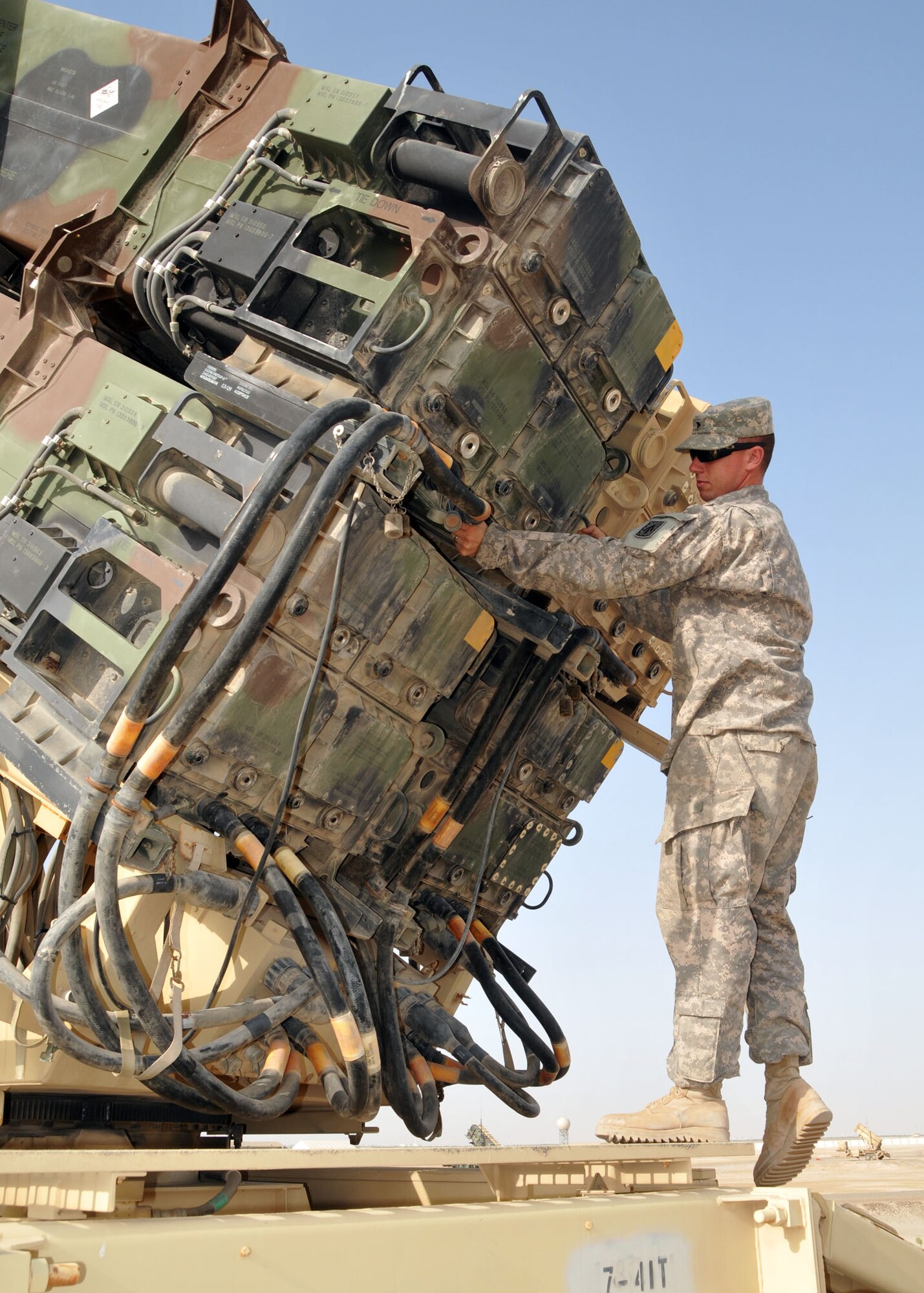 Army Spc. Kyle Ives, launching station crew member, checks cables on a Patriot missile launcher assigned to Charlie Battery, 3rd Battalion, 4th Air Defense Artillery Regiment. The Patriot missiles defend against airborne threats to the 380th Air Expeditionary Wing at an undisclosed location in Southwest Asia on April 24, 2014. (U.S. Air Force photo by Senior Master Sgt. Eric Peterson/Released)


