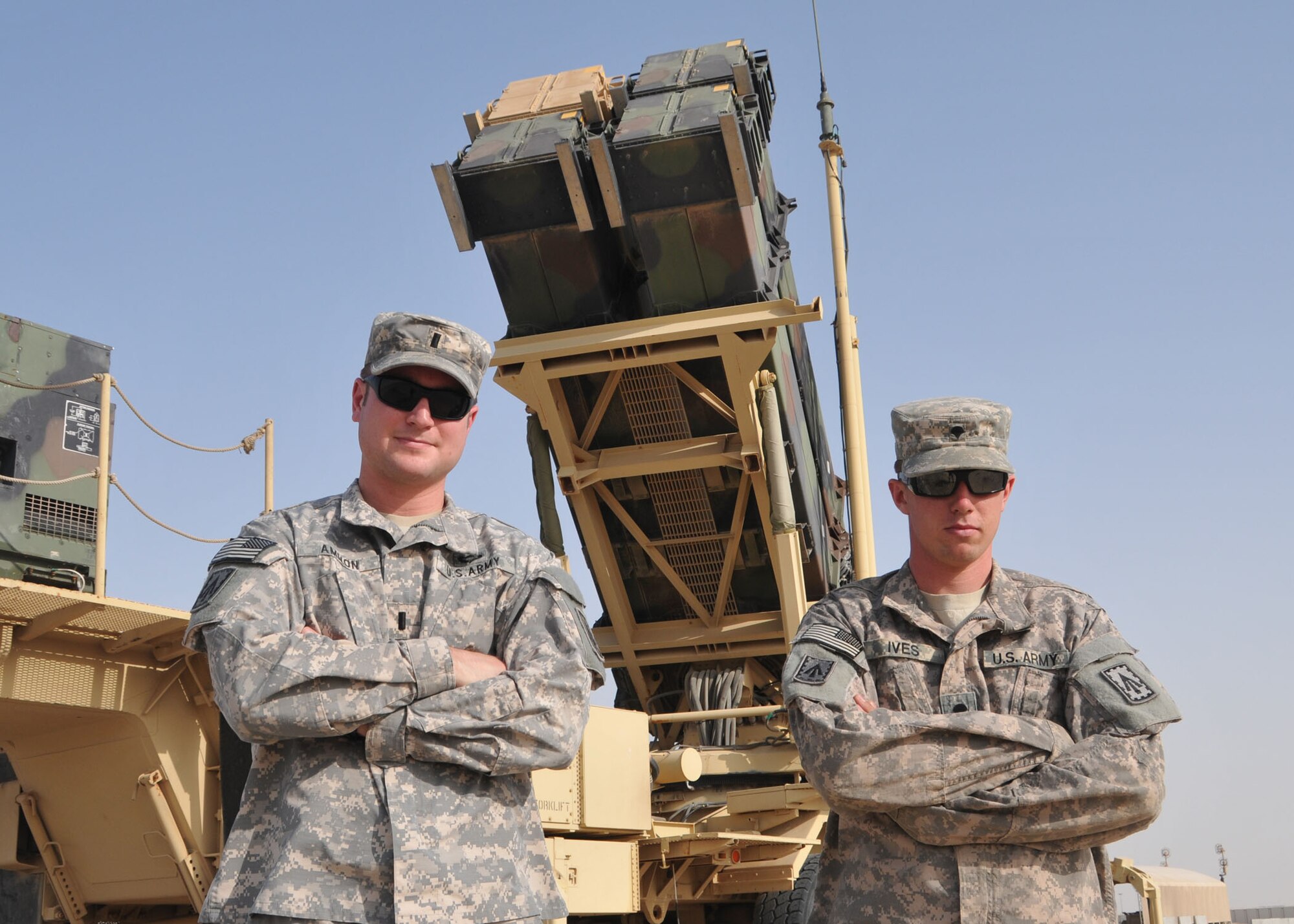 Army 1st Lt. Joseph Ammon, tactical control officer, and Army Spc. Kyle Ives, launching station crew member, from Charlie Battery, 3rd Battalion, 4th Air Defense Artillery Regiment stand in front of a Patriot missile launcher that defends the 380th Air Expeditionary Wing against airborne threats at an undisclosed location in Southwest Asia on April 24, 2014. (U.S. Air Force photo by Senior Master Sgt. Eric Peterson/Released)