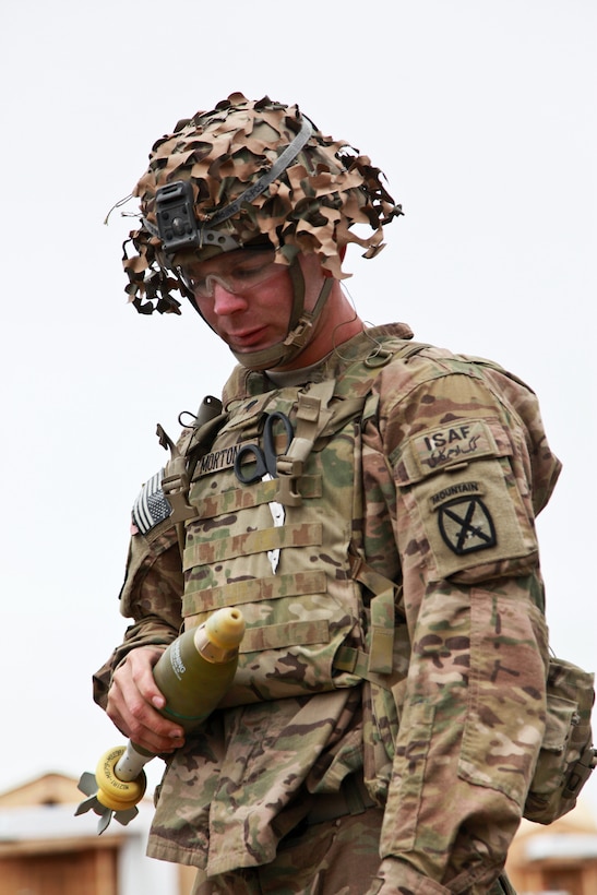 U.S. Army Spc. Nicholas Morton holds an 81mm mortar round during training on Forward Operating Base Lightning in Afghanistan's Paktia province, April 25, 2014. Morton is assigned to 10th Mountain Division's 3rd Squadron, 71st Calvary Regiment, 3rd Brigade Combat Team.
