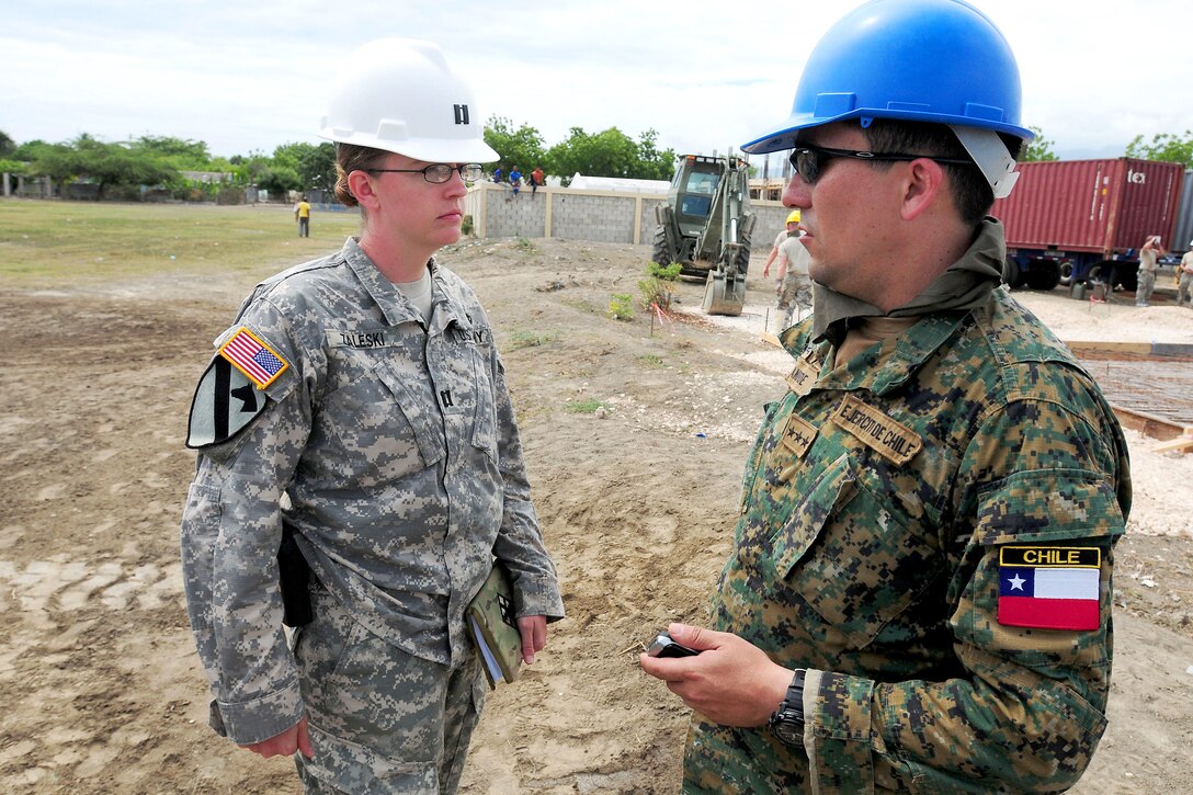U.S. Army Capt. Zaleski, left, talks to a Chilean soldier about construction progress on a new school during Beyond the Horizon 2014 in Barahona, Dominican Republic, April 22, 2014. Zaleski is assigned to Task Force Larimar.