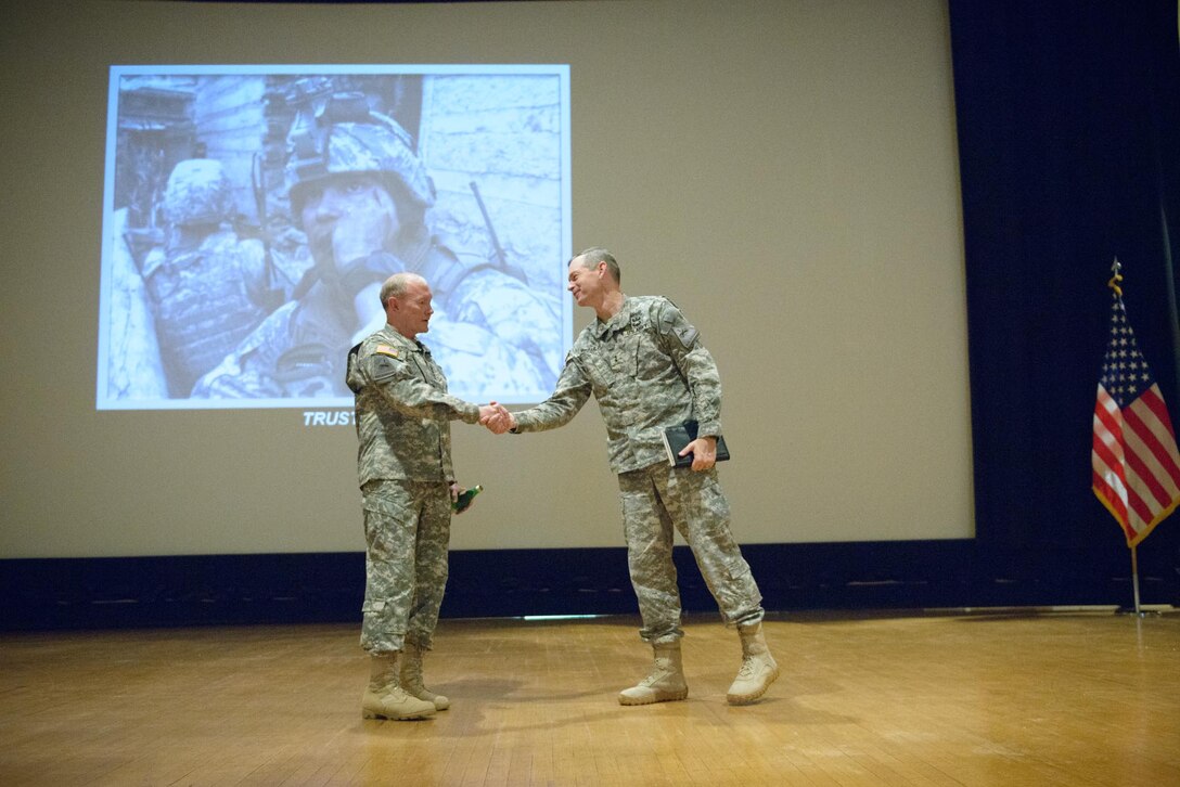 Army Maj. Gen. Sean MacFarland, right, commanding general of the 1st Armored Division, shakes hands with Army Gen. Martin E. Dempsey, left, chairman of the Joint Chiefs of Staff, after a leader development discussion on Fort Bliss, Texas, April 25, 2014.