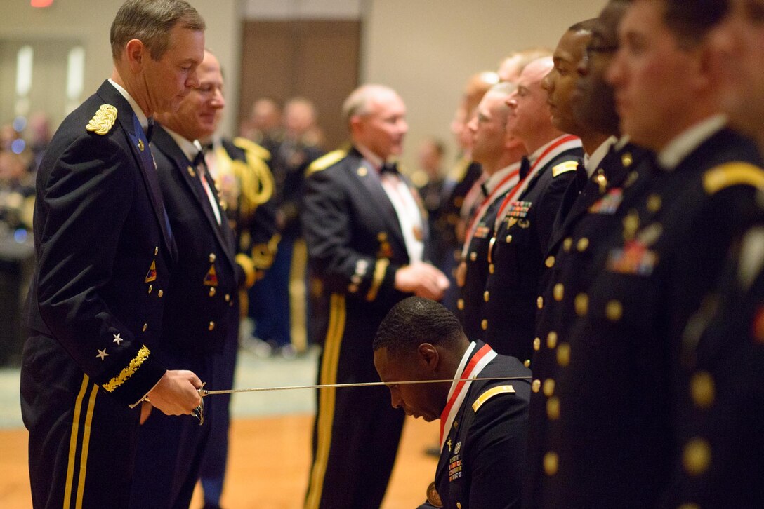 Army Maj. Gen. Sean MacFarland, commanding general of the 1st Armored Division, awards the Order of St. George at the St. George Ball honoring the Armor and Cavalry branches of the 1st Armored Division on Fort Bliss, Texas, April 25, 2014.  