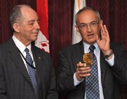 Robert E. Slockbower, Army Corps of Engineers Southwestern Division’s Director of Military Programs, presents Ralph Schuler with a surveyor’s compass during his retirement ceremony April 25, explaining how it is representative of his leadership, vision and contributions across the Army Corps of Engineers. 