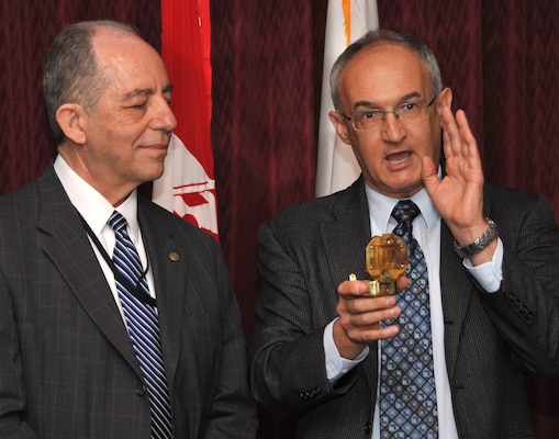 Robert E. Slockbower, Army Corps of Engineers Southwestern Division’s Director of Military Programs, presents Ralph Schuler with a surveyor’s compass during his retirement ceremony April 25, explaining how it is representative of his leadership, vision and contributions across the Army Corps of Engineers. 