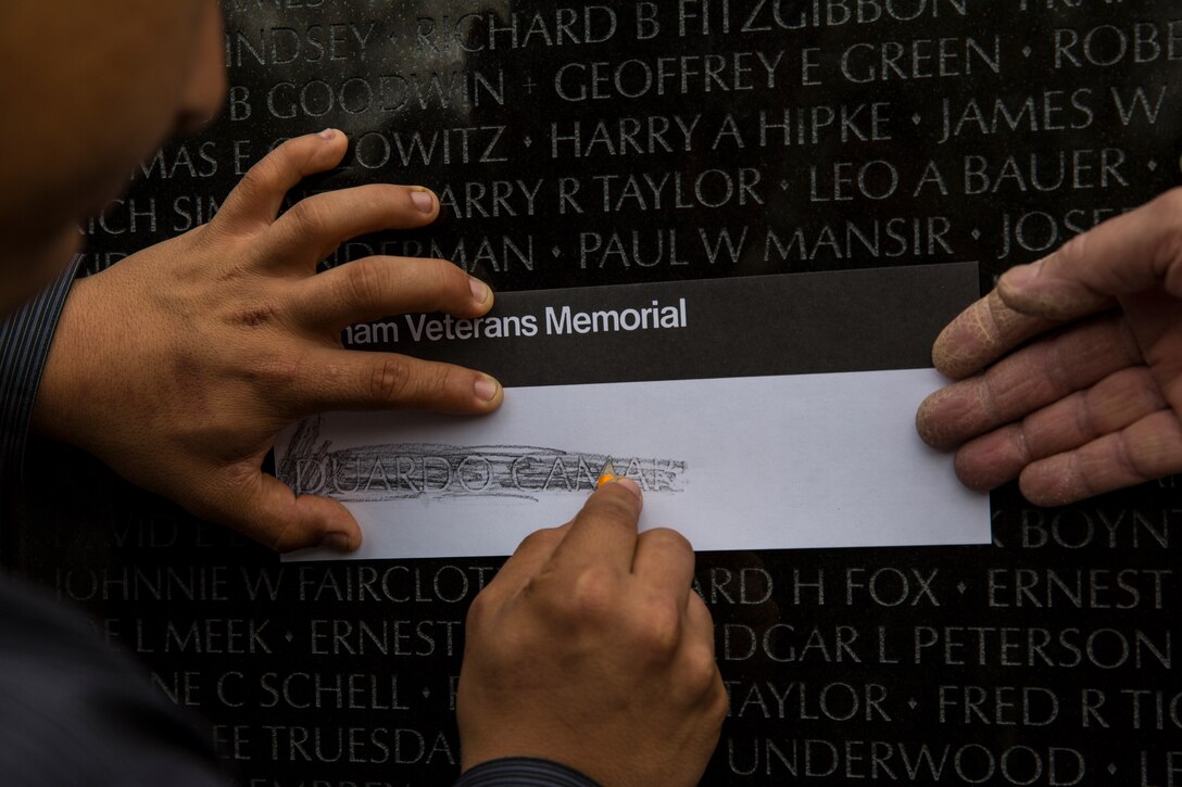 A Marine with 3rd Marine Aircraft Wing etches a name from the Vietnam Veterans Memorial in Washington, D.C., during a Committed and Engaged Leadership Seminar, April 25.  The Marines also visited Marine Barracks Washington, D.C., Arlington National Cemetery and the National Museum of the Marine Corps.