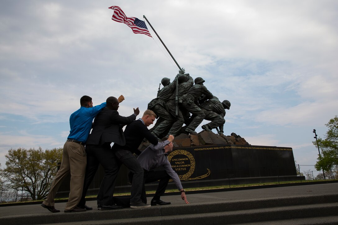 Marines with the 3rd Marine Aircraft Wing imitate the famous raising of the flag at Iwo Jima, Japan, the Marine Corps War Memorial at in Washington, D.C., during a Committed and Engaged Leadership Seminar, April 25. The Marines also visited Marine Barracks Washington, D.C., Arlington National Cemetery and the National Museum of the Marine Corps. 