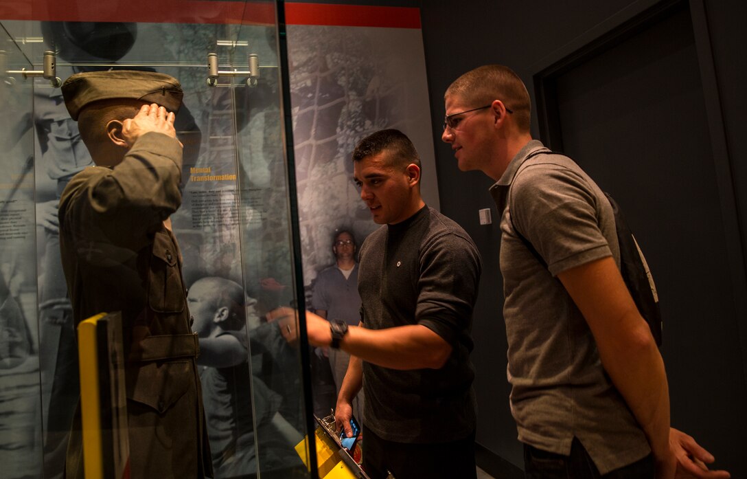 Cpl. Ruben Madriles (left), flight equipment technician with Marine Fight Attack Squadron (All-Weather) 225 and an Albuquerque, N.M., native, and Cpl. Kyle Venstrom, aviation ordnance specialist with Marine Aviation Logistics Squadron 11 and a Wilmington, Ill., native, look at a display of a service uniform at the National Museum of the Marine Corps during a two-day Committed and Engaged Leadership Seminar in Washington, D.C., April 26. The museum spans the history of the Marine Corps since 1775. 