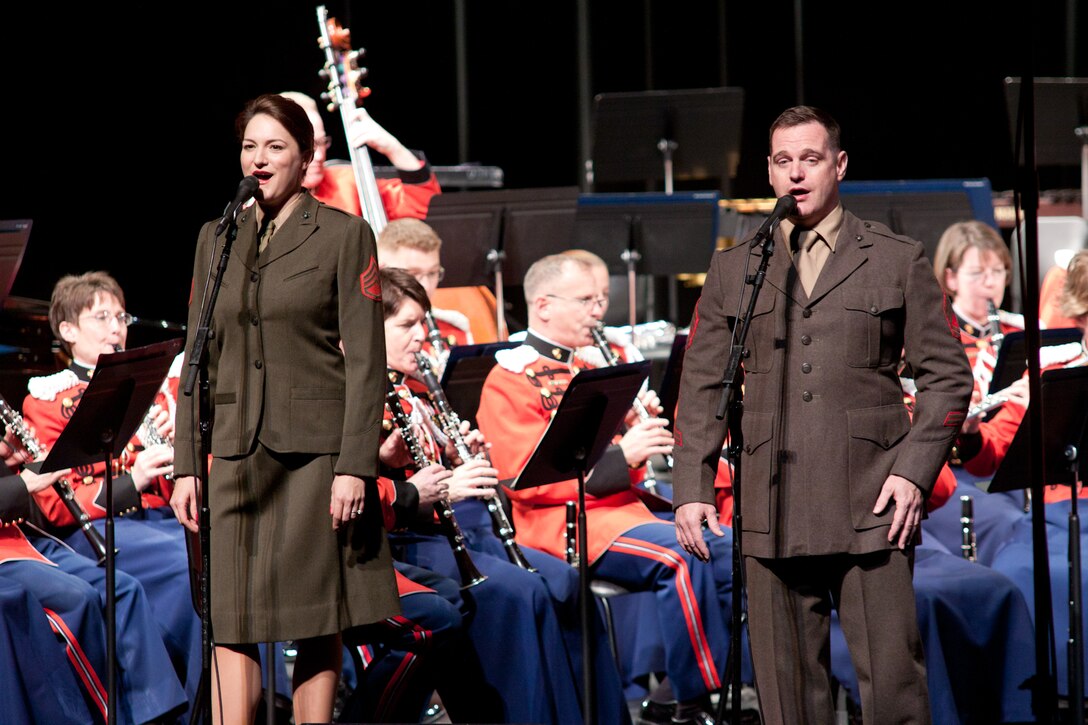 Gunnery Sgt. Sara Dell'Omo and Master Sgt. Kevin Bennear sing a medley of popular World War II era hits dressed in period uniforms at the Bowie Center for the Performing Arts.(U.S. Marine Corps photo by Staff Sgt. Brian Rust/released)