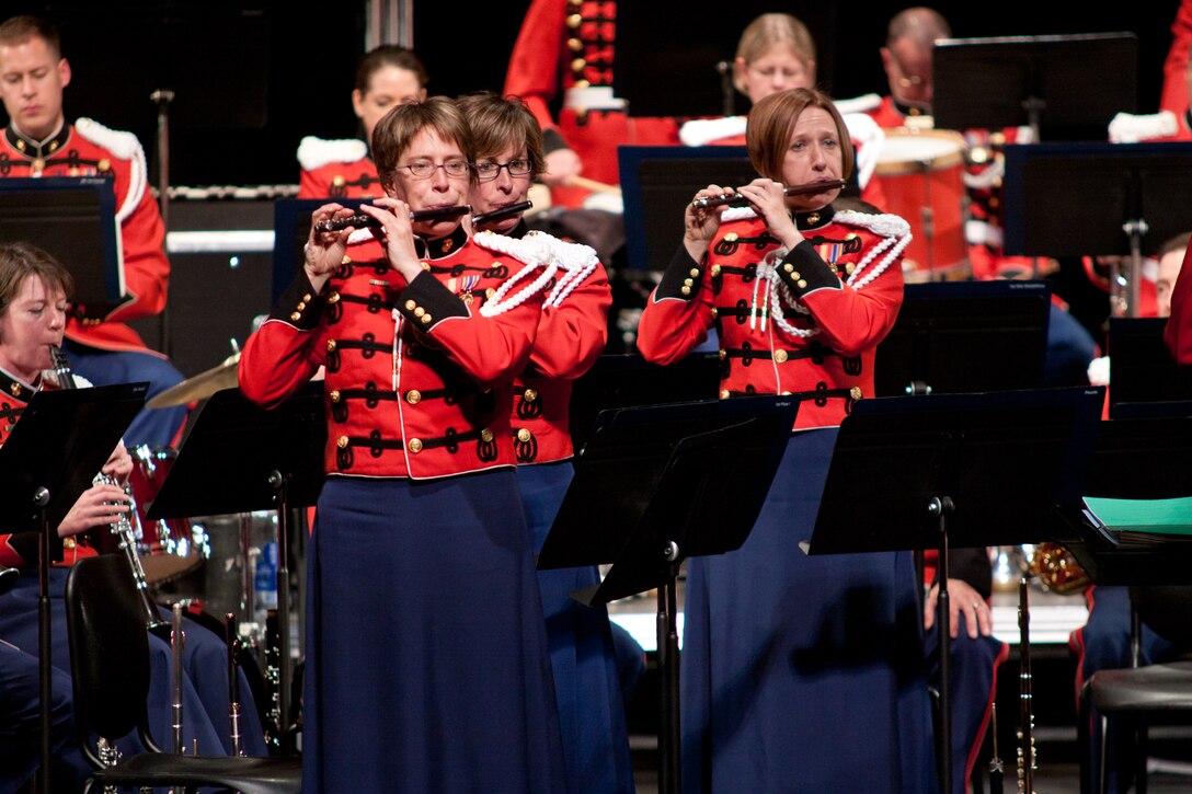 Piccolo players Staff Sgt. Heather Zenobia, Master Gunnery Sgt. Betsy Hill, and Staff Sgt. Ellen Dooley play the piccolo solo during The Stars and Stripes Forever. (U.S. Marine Corps photo by Staff Sgt. Brian Rust/released)