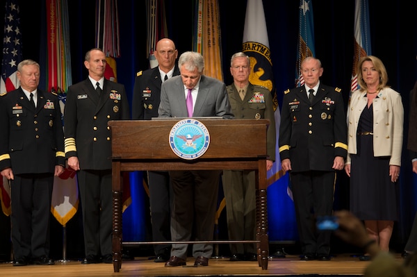 Defense Secretary Chuck Hagel signs the Human Goals Charter during a ceremony at the Pentagon, April 28, 2014.