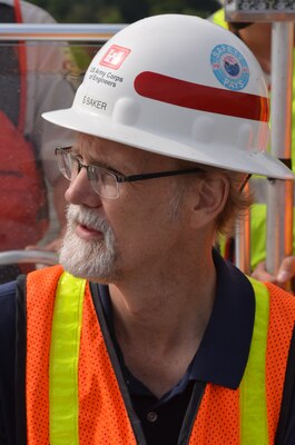 LANSING, Iowa -- Scott Baker, St. Paul District resident engineer civil engineer, looks at the Pool 9 island construction project near Lansing, Iowa, Aug. 23. the project is a part of the Upper Mississippi River Restoration Program.