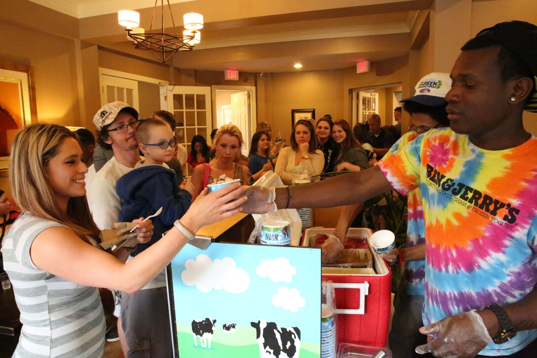 Employees from Ben and Jerry’s in Fairfax, serve ice cream during a Lyman Park community block party at the Lincoln Military Housing family Center on April 22, 2014. More than 400 people participated in the event which was one of six 2014 Quantico community block parties. 