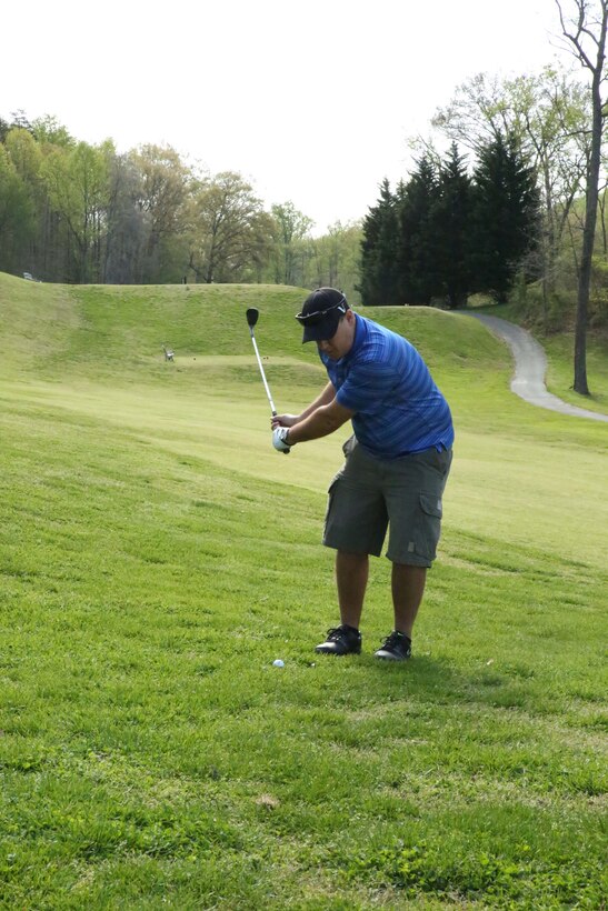 Frank Brewster, golfer, swings in an attempt to land a ball on the green during the Putt for the Paw Golf Tournament at the Medal of Honor Golf Course on April 25, 2014. The event was hosted by the golf course and the Washington, D.C., chapter of Pets for Vets organization. 