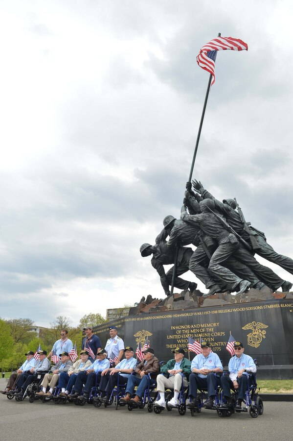 World War II veterans and a few guardians stand by the Iwo Jima monument for photo opportunities during an Austin, Texas,  Honor Flight event at the World War II Memorial in Washington, D.C., on April 26, 2014. For many of the volunteer guardians, this was their first time participating in an Honor Flight event. (Marine Corps Photo by Cpl. Antwaun Jefferson)