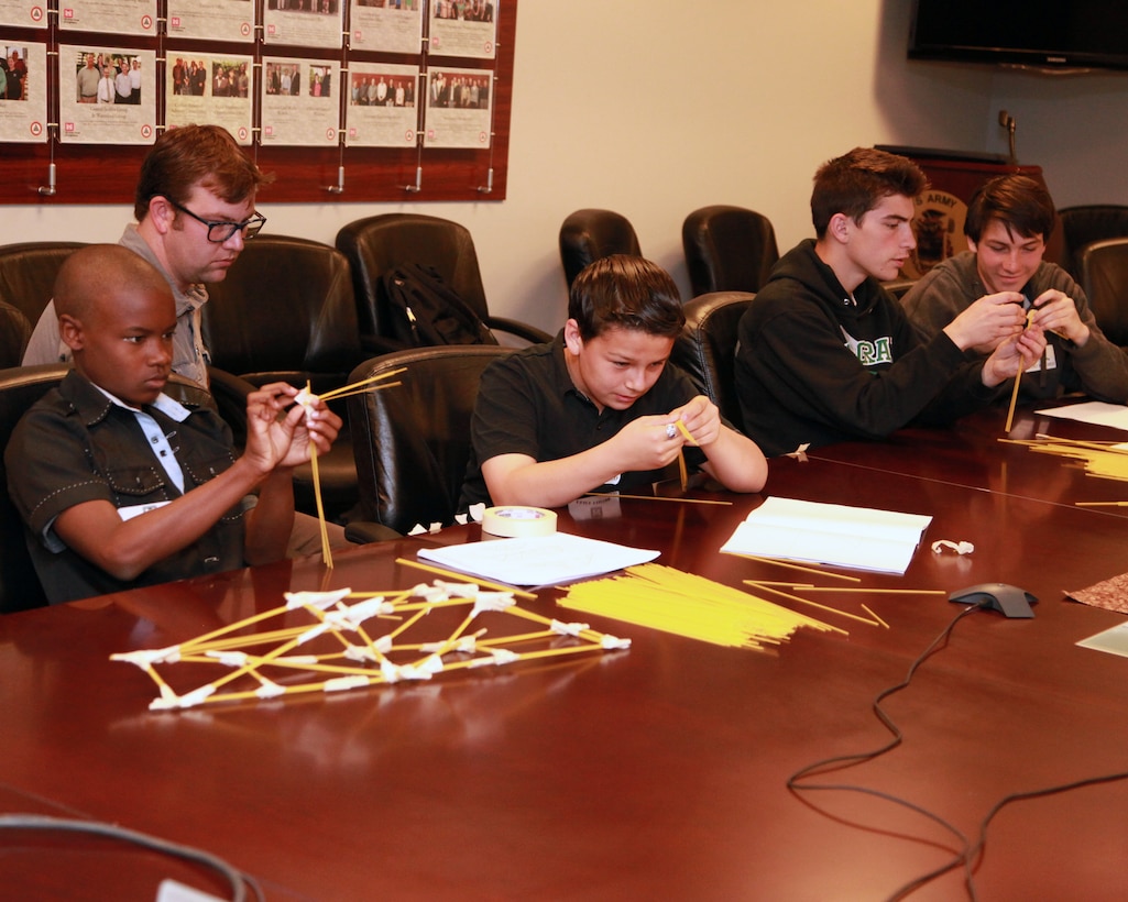 Brian Smith, Alexander Burrola, Jude McIntosh and Gage McIntosh construct a spaghetti bridge under the watchful eye of Corps intern AJ Moore during the 21st Annual Take Our Daughters And Sons To Work® program held at the district offices in Los Angeles April 24. Nearly two dozen children of U.S. Army Corps of Engineers Los Angeles District employees participated in the event.