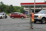 An Arkansas Army National Guard Soldier from the Conway based Special Troops Battalion, 39th Infantry Brigade Combat Team, directs traffic at an intersection in Mayflower, Ark. April 28, 2014. Guard members were called up to respond to their fellow neighbors in need after a severe weather and tornadoes devastated communities in central Arkansas April 27, 2014.