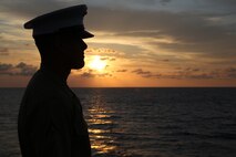 Lance Cpl. Thomas V. Scrimo, native of Atlanta, Ga., and amphibious assault vehicle crewman with 2nd Assault Amphibian Battalion, 2nd Marine Division, Marine Corps Base Camp Lejeune, N.C., watches the sunrise on the flight deck in preparation for manning the rails as the USS New York (LPD 21) sails into South Florida for Fleet Week Port Everglades 2014, April 28. Approximately 120 Marines from 2nd AAV Bn., 2nd Battalion, 6th Marine Regiment, 2nd Marine Division, Marine Corps Base Camp Lejeune, N.C., and Marine Light Attack Helicopter Squadron (HMLA) 269, Marine Corps Air Station New River, N.C., are participating in the 24th Annual Fleet Week in Port Everglades; South Florida’s annual celebration of maritime forces. (U.S. Marine Corps photo by Sgt. Alicia R. Leaders/Released)