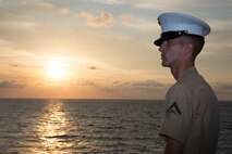 Lance Cpl. Ethan C. Hogeland, native of Fayetteville, N.C., and amphibious assault vehicle crewman with 2nd Assault Amphibian Battalion, 2nd Marine Division, Marine Corps Base Camp Lejeune, N.C., watches the sunrise on the flight deck in preparation for manning the rails as the USS New York (LPD 21) sails into South Florida for Fleet Week Port Everglades 2014, April 28. Approximately 120 Marines from 2nd AAV Bn., 2nd Battalion, 6th Marine Regiment, 2nd Marine Division, Marine Corps Base Camp Lejeune, N.C., and Marine Light Attack Helicopter Squadron (HMLA) 269, Marine Corps Air Station New River, N.C., are participating in the 24th Annual Fleet Week in Port Everglades; South Florida’s annual celebration of maritime forces. (U.S. Marine Corps photo by Sgt. Alicia R. Leaders/Released)