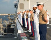 Lance Cpl. Mark S. Frick (right), native of White Hall, Md., and amphibious assault vehicle crewman with 2nd Assault Amphibian Battalion, 2nd Marine Division, Marine Corps Base Camp Lejeune, N.C., stands at parade rest with fellow Marines and Sailors while manning the rails as the USS New York (LPD 21) sails into South Florida for Fleet Week Port Everglades 2014, April 28. Approximately 120 Marines from 2nd AAV Bn., 2nd Battalion, 6th Marine Regiment, 2nd Marine Division, Marine Corps Base Camp Lejeune, N.C., and Marine Light Attack Helicopter Squadron (HMLA) 269, Marine Corps Air Station New River, N.C., are participating in the 24th Annual Fleet Week in Port Everglades; South Florida’s annual celebration of maritime forces. (U.S. Marine Corps photo by Sgt. Alicia R. Leaders/Released)