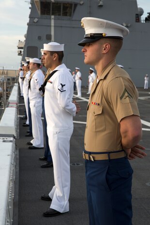Lance Cpl. Justin R. Smith, Dickson, Tenn., and amphibious assault vehicle crew chief with 2nd Assault Amphibian Battalion, 2nd Marine Division, Marine Corps Base Camp Lejeune, N.C., stands at parade rest with fellow Marines and Sailors while manning the rails as the USS New York (LPD 21) sails into South Florida for Fleet Week Port Everglades 2014, April 28. Approximately 120 Marines from 2nd AAV Bn., 2nd Battalion, 6th Marine Regiment, 2nd Marine Division, Marine Corps Base Camp Lejeune, N.C., and Marine Light Attack Helicopter Squadron (HMLA) 269, Marine Corps Air Station New River, N.C., are participating in the 24th Annual Fleet Week in Port Everglades; South Florida’s annual celebration of maritime forces. (U.S. Marine Corps photo by Sgt. Alicia R. Leaders/Released)