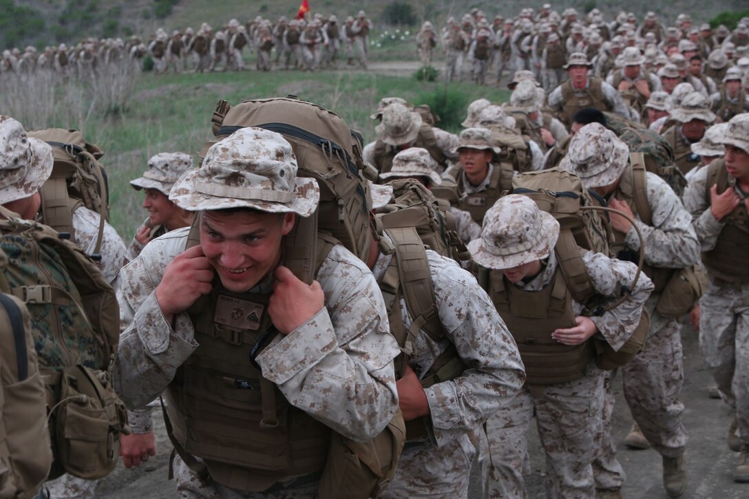 Cpl. Justin R. Wiemer, a motor vehicle mechanic with I Marine Headquarters Group, climbs a hill during a regimental hike aboard Camp Pendleton, Calif., April 17, 2014. The Marines wore their flak jackets and carried weighted assault packs on the eight-mile conditioning hike. This hike was the second of a series in a series of conditioning events that aim to improve the Marines operational readiness and camaraderie.