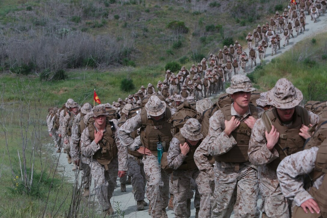 Marines with I Marine Headquarters Group push up a hill during a regimental hike conducted aboard Camp Pendleton, Calif., April 17, 2014. The Marines wore their flak jackets and carried weighted assault packs on the eight-mile conditioning hike. This hike was the second of a series in a series of conditioning events that aim to improve the Marines operational readiness and camaraderie.