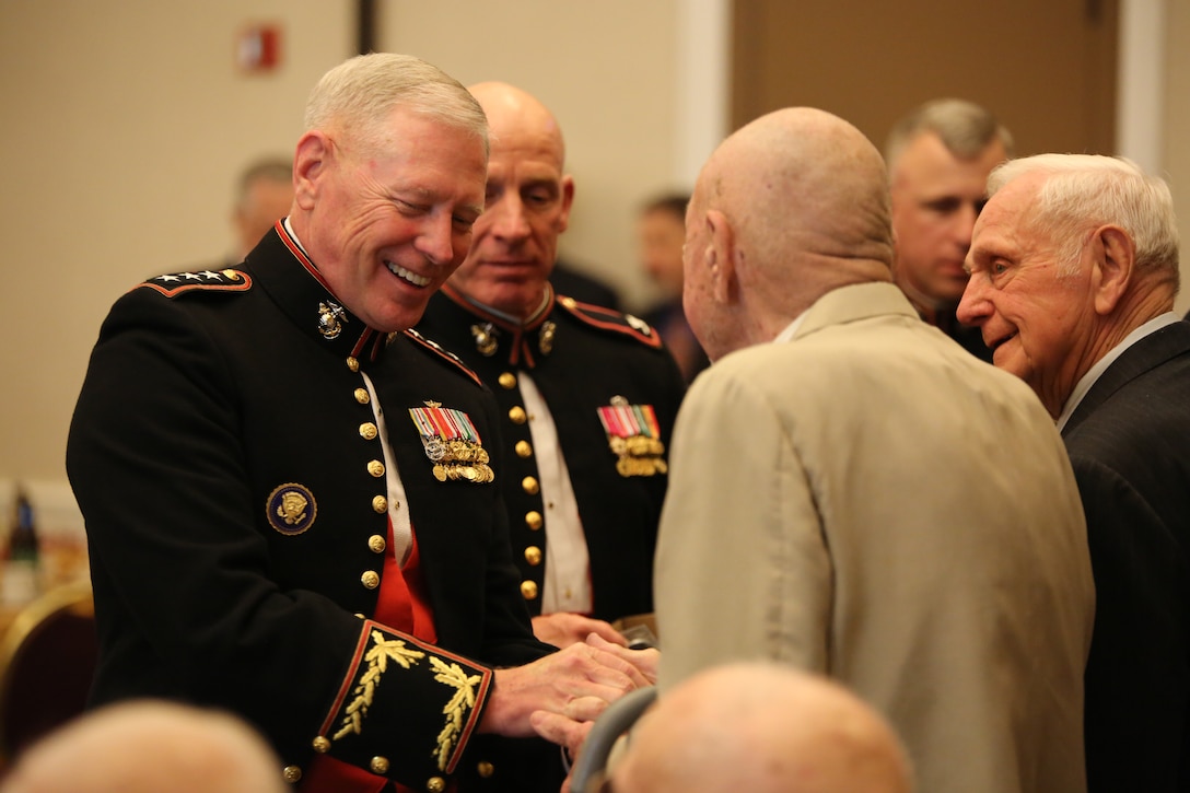 Lt. Gen Kenneth Glueck, the commanding officer for Marine Corps Combat Development Command, honors former members of the 1st Marine Raider Battalion during the 66-year reunion at the Clubs of Quantico on April 26, 2014. Eight Marine Raiders attended the event to celebrate their accomplishments and to remember their brother Raiders.