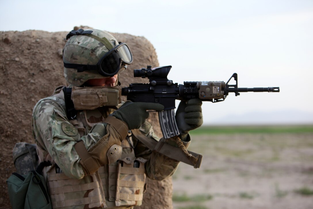 A Georgian soldier with the 31st Georgian Light Infantry Battalion stands outside a compound and watches for suspicious activity as the Afghan National Army soldiers clear the compound in Helmand province, Afghanistan, April 12, 2014. The platoon of Georgian soldiers with the 31st GLIB and Marines of the Georgian Liaison Team conducted a synchronized helicopter-borne and motorized raid in order to capture a high-value target, led by ANA soldiers. (USMC Photo By: Sgt. Frances Johnson/released)