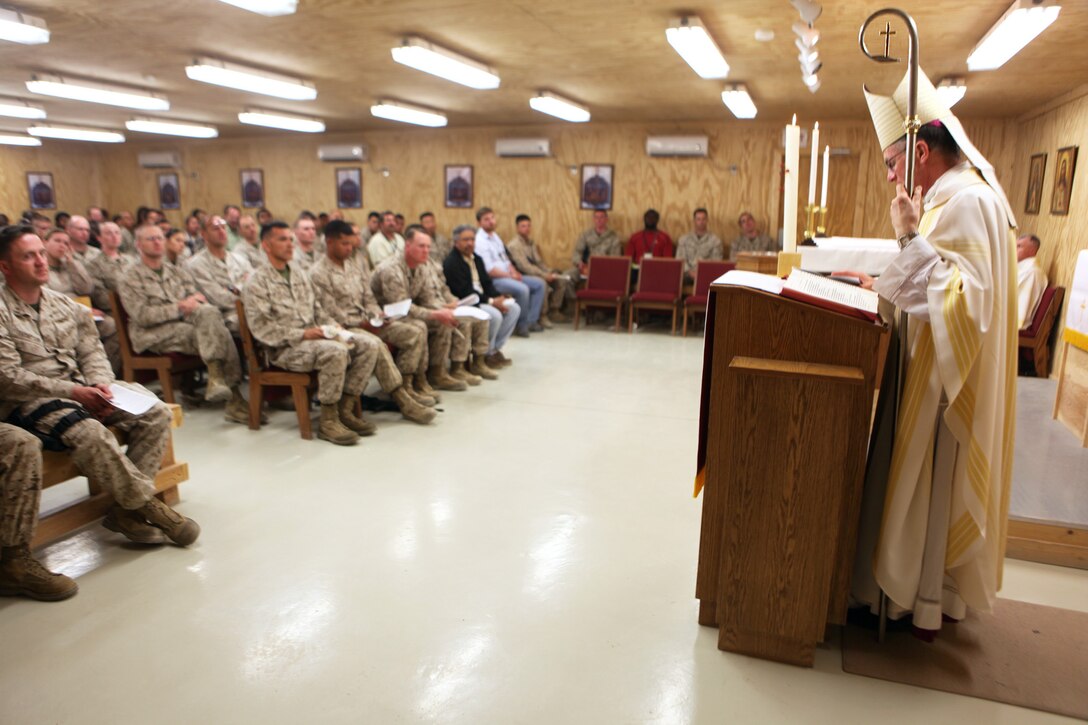 Archbishop Timothy P. Broglio, right, who leads the Roman Catholic Archdiocese for the military services, conducts Easter Vigil Mass aboard Camp Leatherneck, Helmand province, Afghanistan, April 19, 2014. The mass included several baptisms and confirmations into the Catholic faith. (U.S. Marine Corps photo by Cpl. Joshua Young)