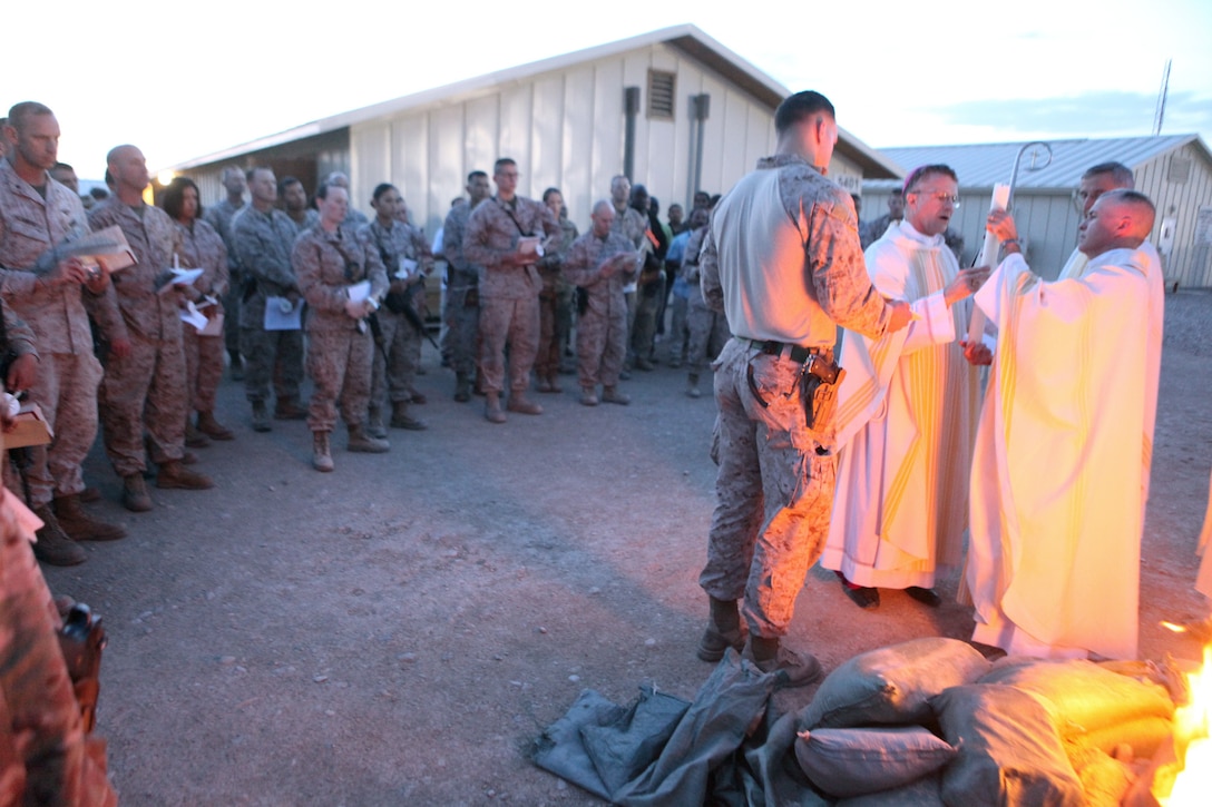 Service members attend Easter Vigil Mass conducted by Archbishop Timothy P. Broglio, who leads the Roman Catholic Archdiocese for the military services aboard Camp Leatherneck, Helmand province, Afghanistan, April 19, 2014. Throughout Holy Week there were many opportunities for people of the Christian faith to meet and share a fellowship with their fellow believers. (U.S. Marine Corps photo by Cpl. Joshua Young)