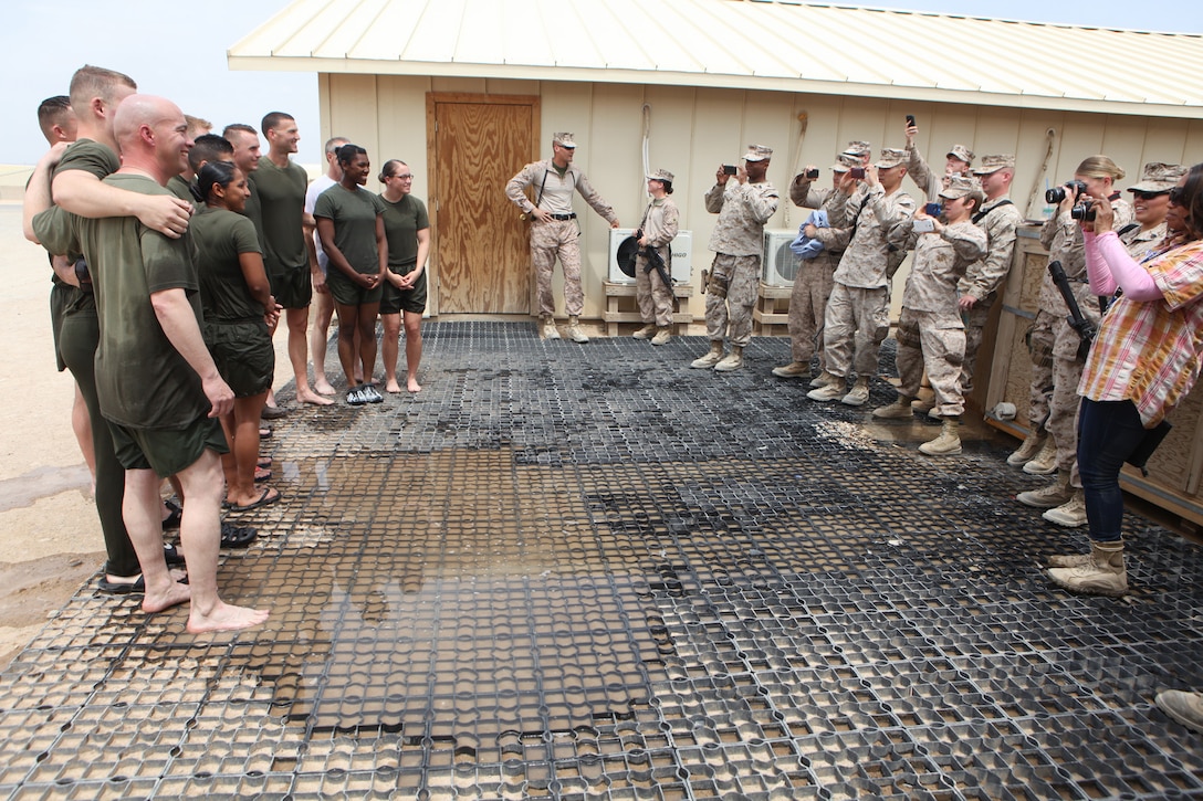 Marines, sailors and a government contractor pose for a photo following an interfaith baptism ceremony held aboard Camp Leatherneck, Helmand province, Afghanistan, April 20, 2014. Two Navy chaplains conducted the ceremony, spoke about the meaning of being baptized and performed the baptisms. (U.S. Marine Corps photo by Cpl. Joshua Young)