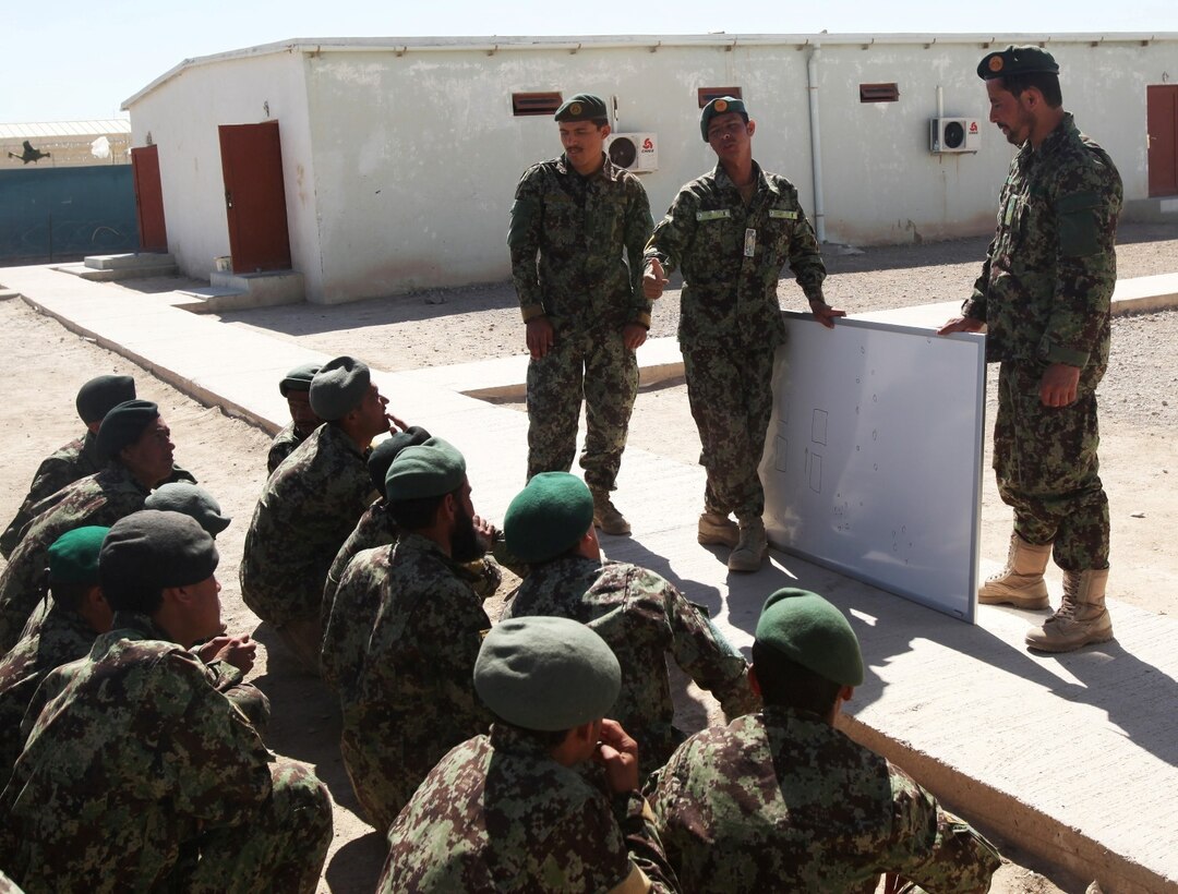 Instructors with 4th Tolai, 6th Kandak, 4th Brigade, 215th Corps, Afghan National Army, give soldiers a class on patrolling tactics during an exercise aboard Camp Shorabak, Afghanistan, April 19, 2014. The training exercise was designed to ensure the efficiency of the soldiers before they begin conducting perimeter patrols with Marines in the area surrounding Camps Bastion, Leatherneck, Shorabak complex. (Marine Corps photo by Cpl. Cody Haas/ released)