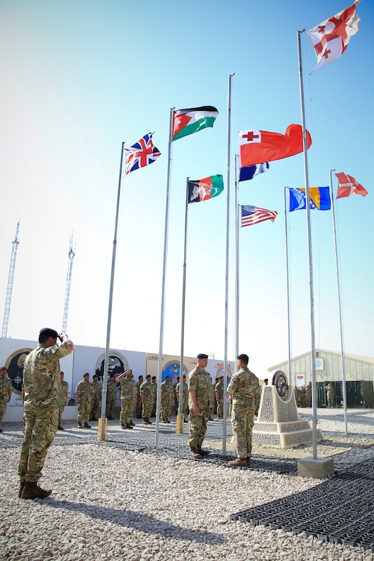 Royal Tongan Marines assigned to Tranche 7, the seventh and final rotational contingent of Royal Tongan Marines to Afghanistan, lower their nation's flag while participating in a ceremony aboard Camp Leatherneck, Helmand province, Afghanistan, April 28, 2014. The lowering of the flag symbolizes the end of the Kingdom of Tonga's participation in Operation Enduring Freedom and return to their homeland. (Official U.S. Marine Corps photo by Lance Cpl. Darien J. Bjorndal, Marine Expeditionary Brigade Afghanistan/ Released)