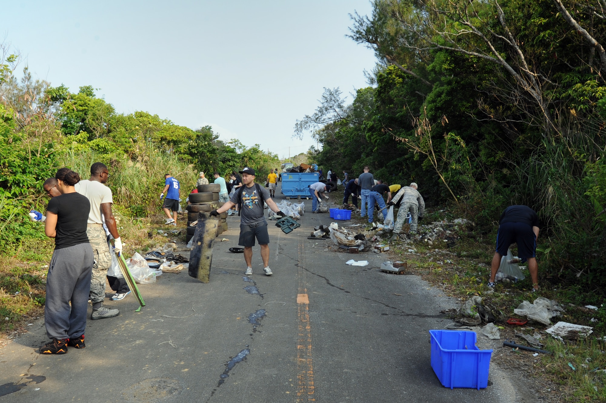 Approximately 80 volunteers from Kadena Air Base pick up garbage during a 718th Civil Engineer Squadron-sponsored jungle cleanup in Yomitan, Okinawa, Japan, April 18, 2014.  The volunteers filled six 10 cubic yard-capacity dumpsters with garbage gathered from a small stretch of jungle adjacent to Kadena’s munitions area.  (U.S. Air Force photo by Airman 1st Class Zade C. Vadnais)