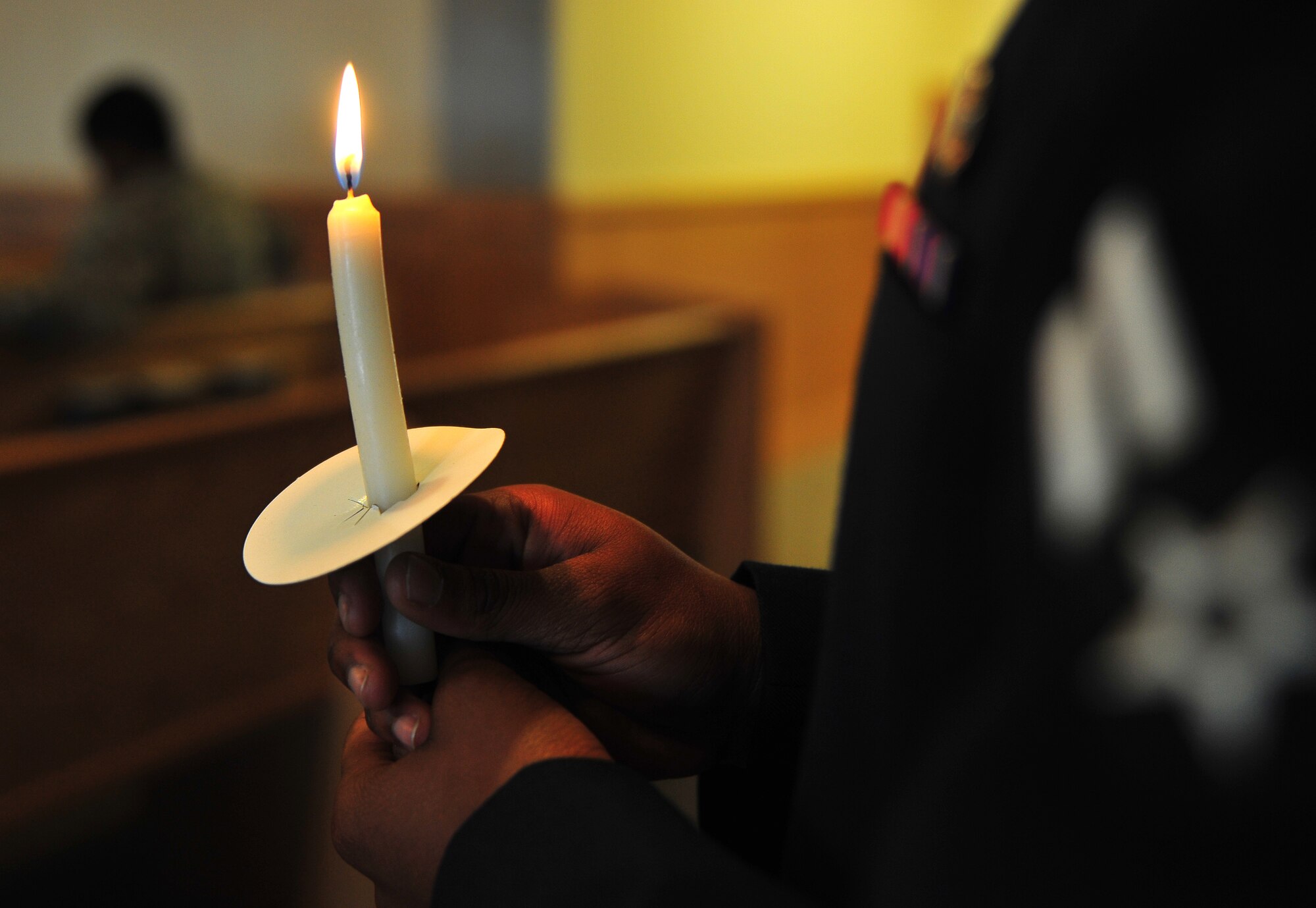 A candlelight is held by U.S. Air Force Airman 1st Class Najala Logan, 35th Security Forces Squadron patrolman, in remembrance of Holocaust victims, during a candlelight vigil at Misawa Air Base, Japan, April 28, 2014. Among the more than six and one-half million Jews who suffered at the hands of the Nazi regime, one and one-half million were children. (U.S. Air Force photo/Senior Airman Jose L. Hernandez-Domitilo)