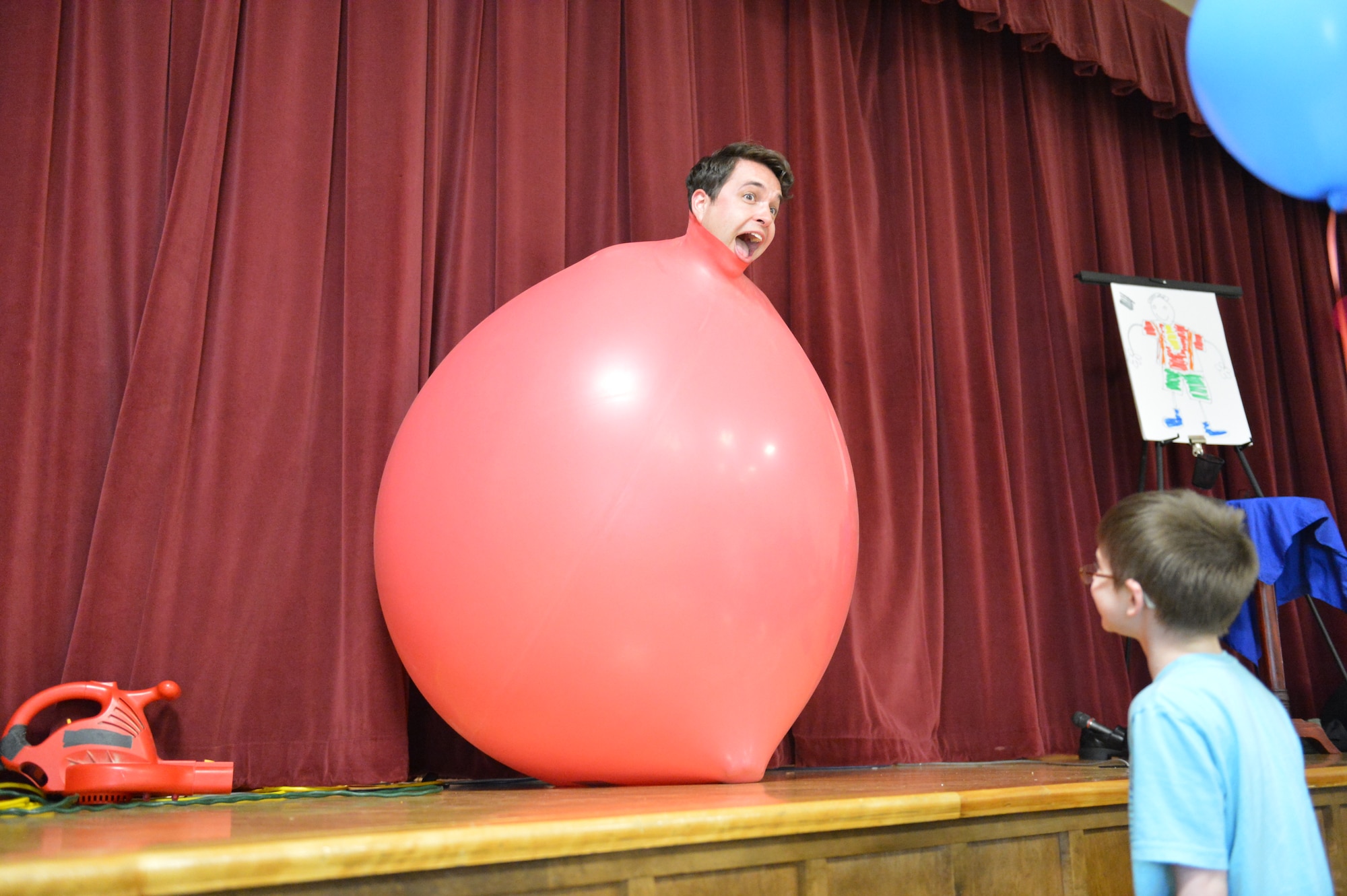 Nate Jester, the Ace of Illusions, performs his final illusion 28 April 2014, for families and children present at the Deployed Family Dinner at Joint Base Lewis-McChord, Wash. Jester volunteered his time to entertain the military families in attendance. (U.S. Air Force photo/Staff Sgt. Russ Jackson)