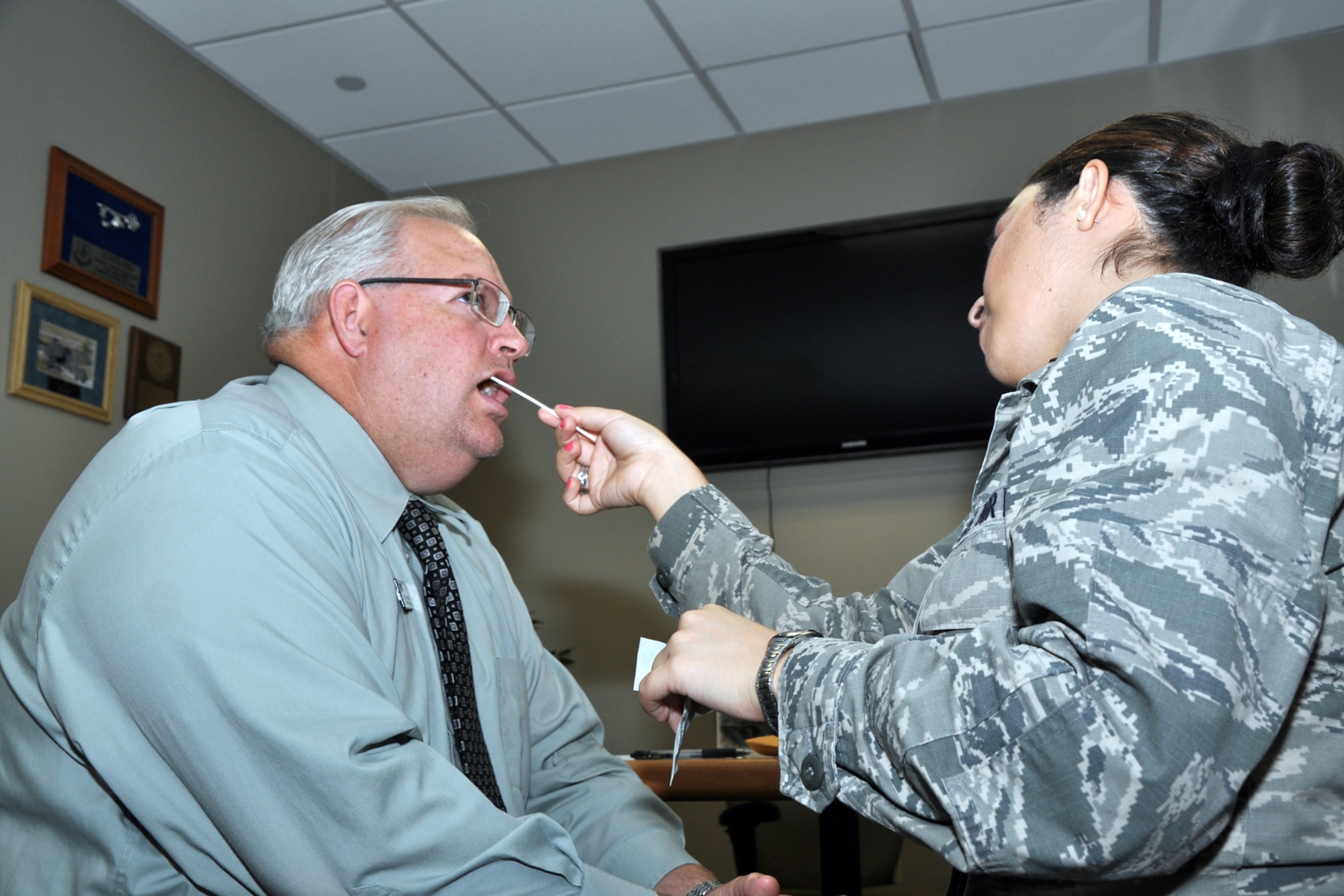 GOODFELLOW AIR FORCE BASE, Texas - First Lt. Pricilla D. Rodriguez, 17th Mission Support Group executive, collects her first DNA sample for the C.W. Bill Young DOD Marrow Donor Program drive in the Public Affairs office here April 24. With his donation, Roger H. Kuhlmann, 17th Mission Support Group flight chief, became Rodriguez's first volunteer. (U.S. Air Force photo/ Senior Airman Joshua Edwards)