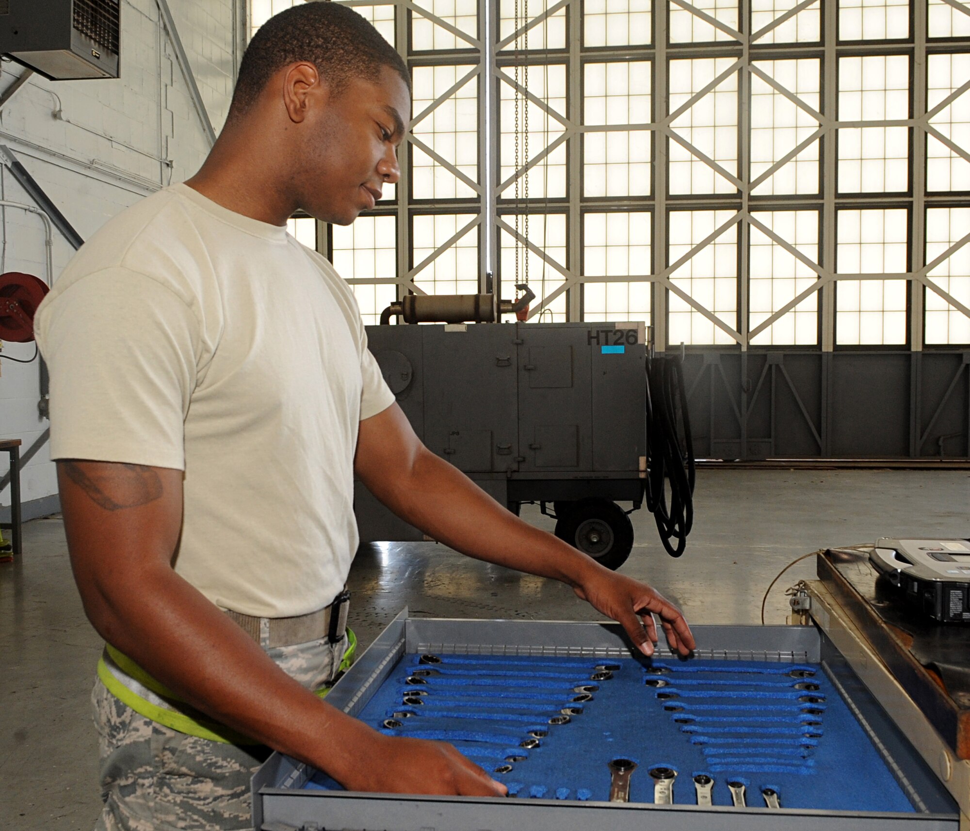Airman 1st Class Marcus Smith, 2nd Maintenance Squadron Aerospace Ground Equipment, reaches for a tool on Barksdale Air Force Base, La., April 29, 2014. AGE Airmen perform various maintenance and preventative maintenance tasks to support flightline Airmen and the B-52H Stratofortress mission on Barksdale. (U.S. Air Force photo/Senior Airman Kristin High)