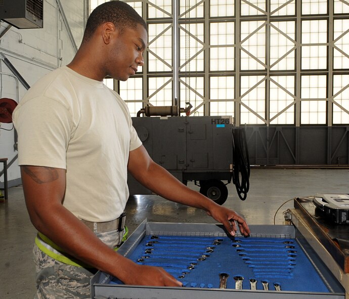 Airman 1st Class Marcus Smith, 2nd Maintenance Squadron Aerospace Ground Equipment, reaches for a tool on Barksdale Air Force Base, La., April 29, 2014. AGE Airmen perform various maintenance and preventative maintenance tasks to support flightline Airmen and the B-52H Stratofortress mission on Barksdale. (U.S. Air Force photo/Senior Airman Kristin High)