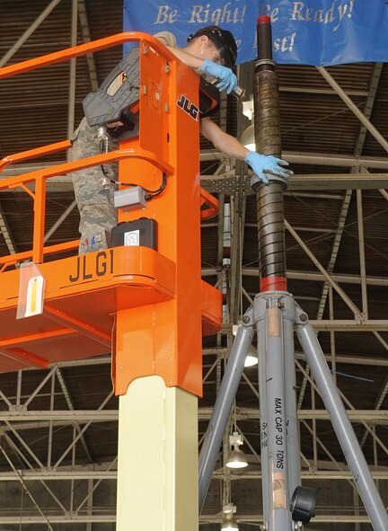 Airman 1st Class Reisen Tschosik, 2nd Maintenance Squadron Aerospace Ground Equipment, oils a tripod jack on Barksdale Air Force Base, La., April 29, 2014. The jack is oiled as part of a preventative maintenance technique to keep the equipment from wearing down over time. (U.S. Air Force photo/ Senior Airman Kristin High) 